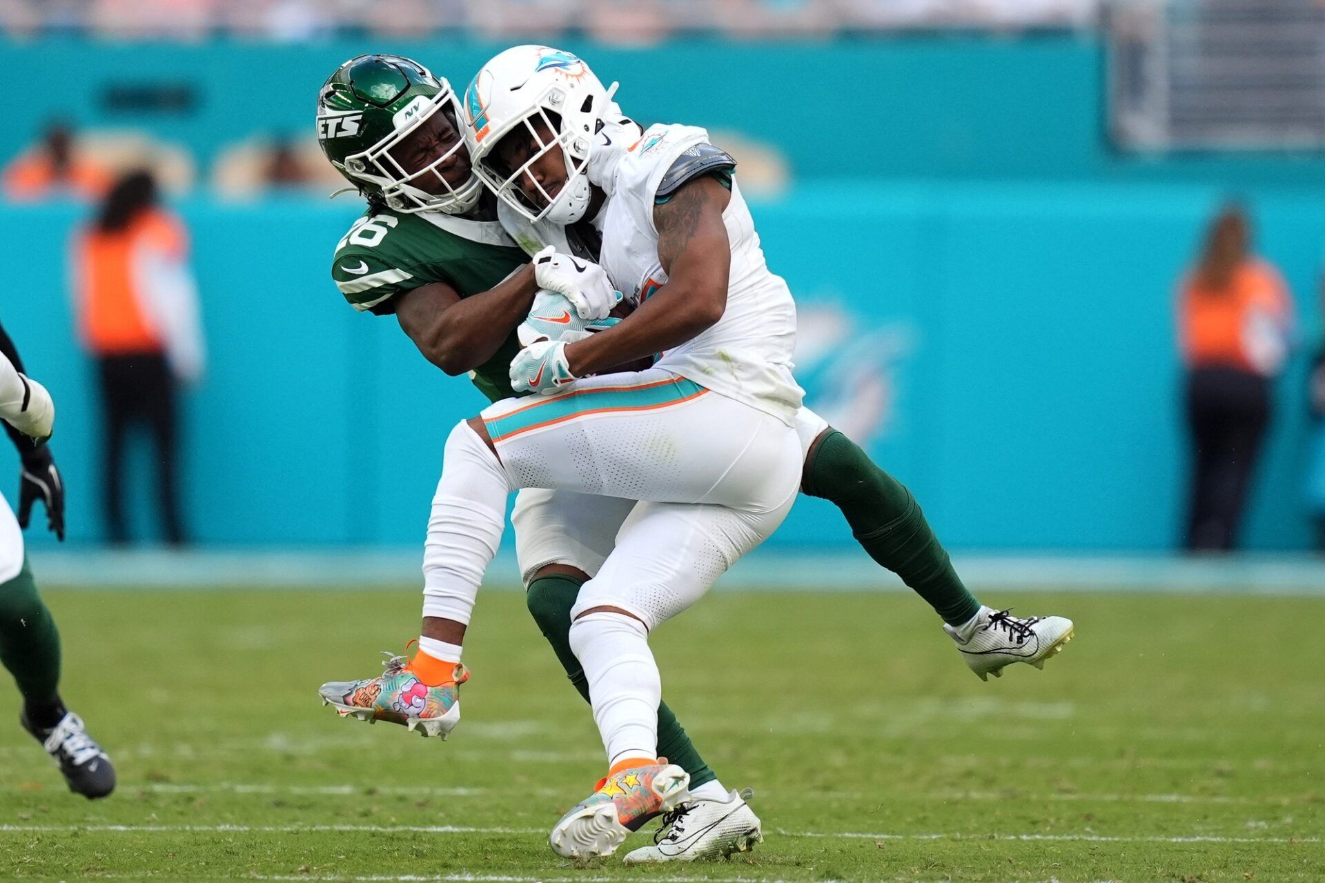 Dec 8, 2024; Miami Gardens, Florida, USA; New York Jets cornerback Brandin Echols (26) attempts to tackle Miami Dolphins wide receiver Jaylen Waddle (17) during the second half at Hard Rock Stadium. Mandatory Credit: Jasen Vinlove-Imagn Images