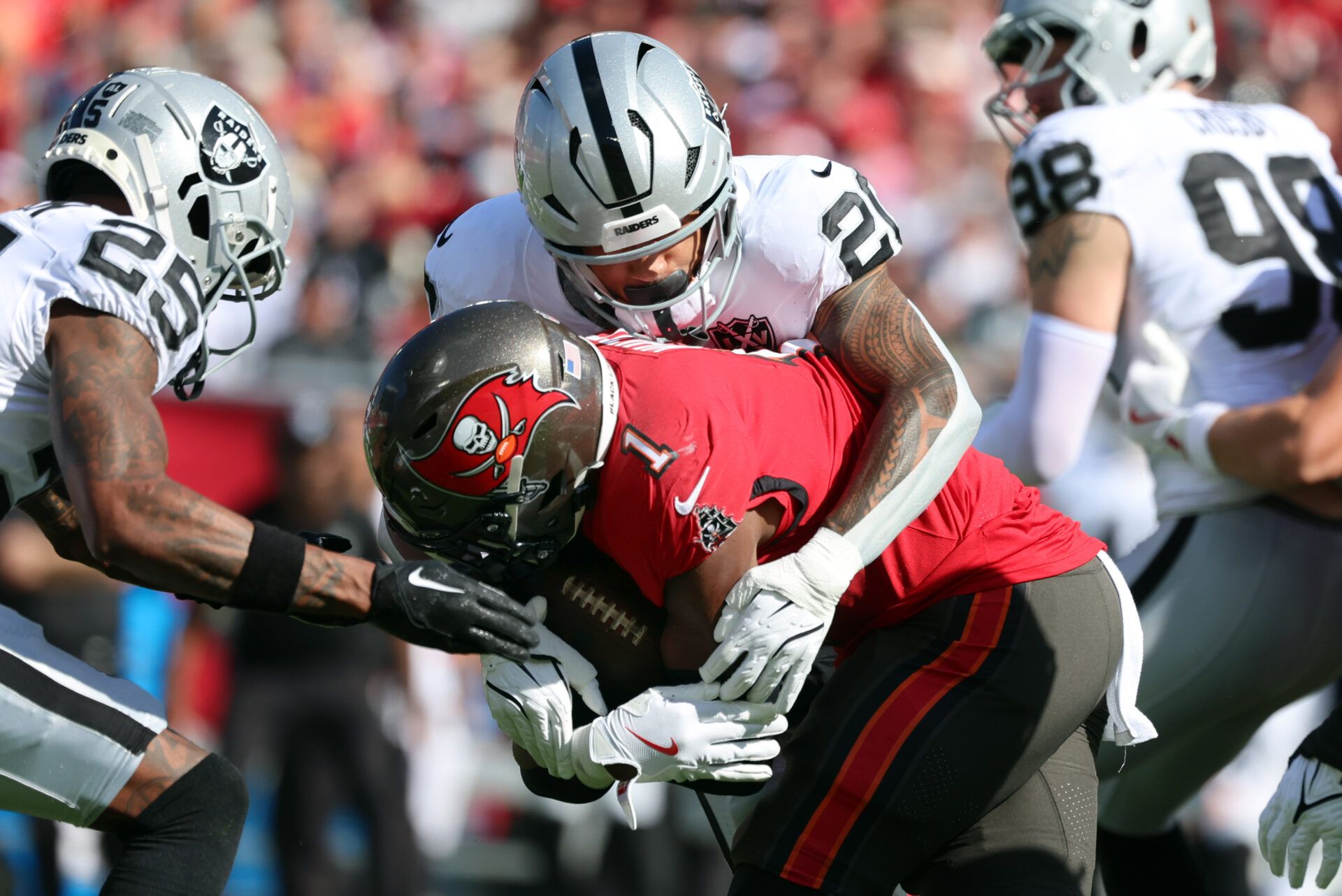 Las Vegas Raiders safety Isaiah Pola-Mao (20) tackles Tampa Bay Buccaneers running back Rachaad White (1) during the first half at Raymond James Stadium.