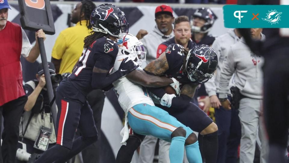 Miami Dolphins wide receiver Tyreek Hill (10) attempts to strip the ball from Houston Texans cornerback Derek Stingley Jr. (24) after an interception during the fourth quarter at NRG Stadium.