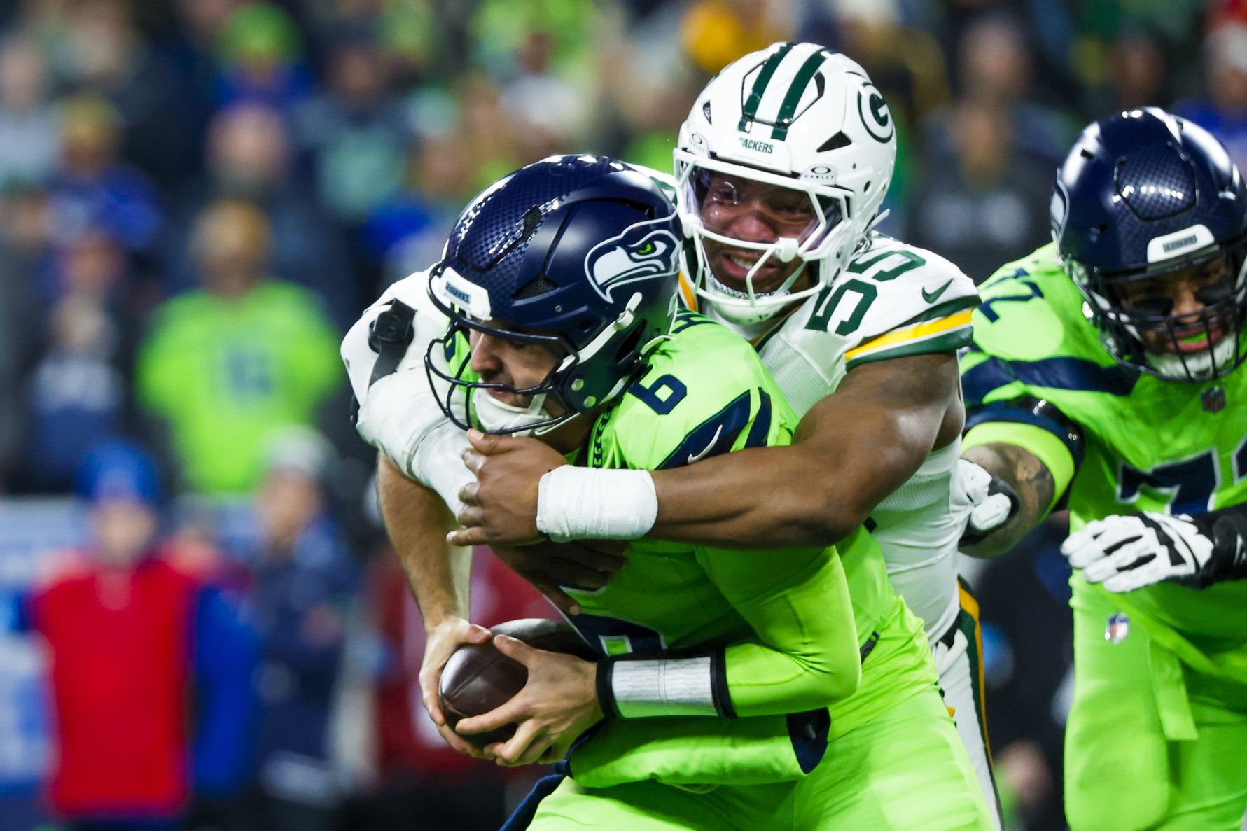 Green Bay Packers defensive end Kingsley Enagbare (55) sacks Seattle Seahawks quarterback Sam Howell (6) during the third quarter at Lumen Field.