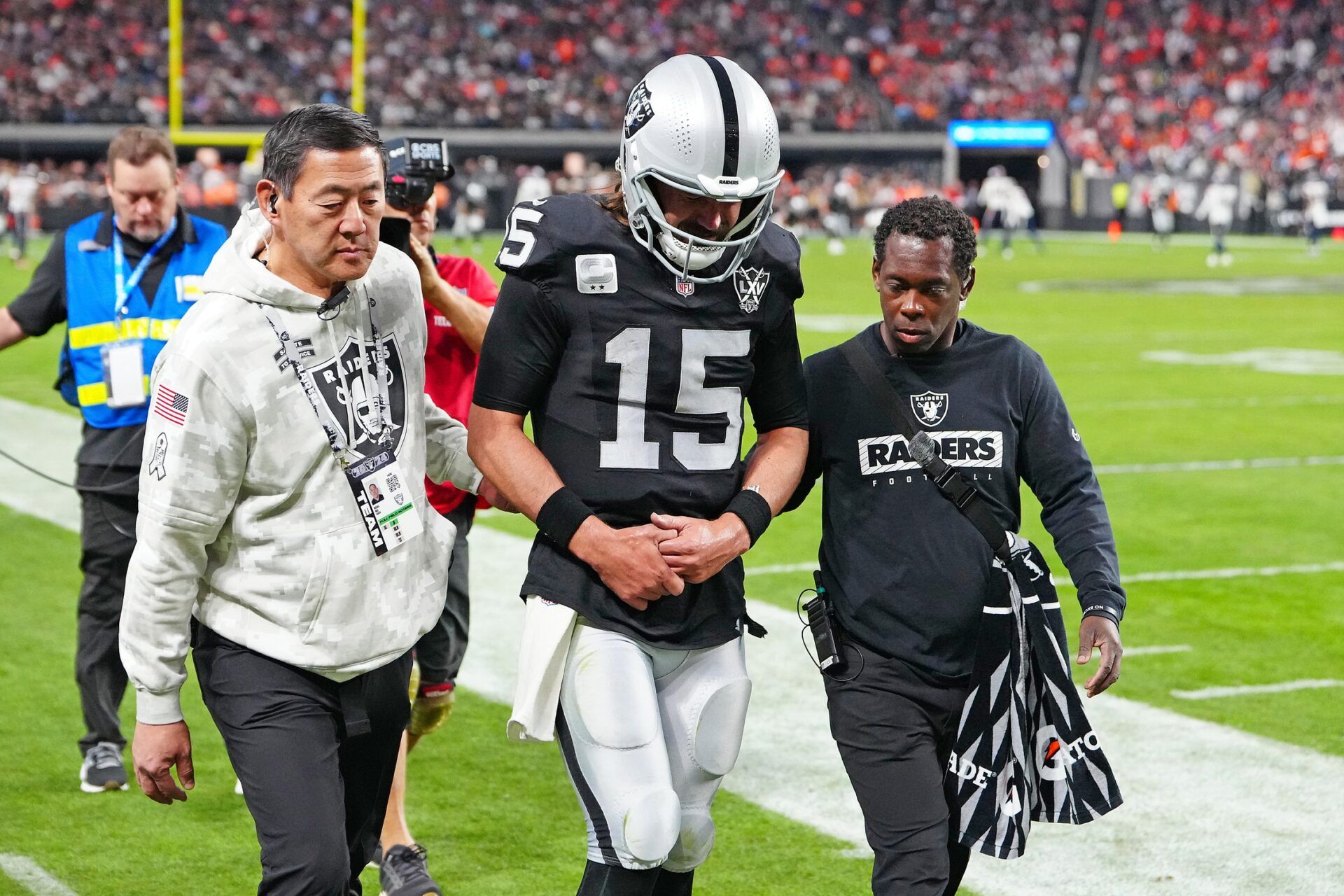 Las Vegas Raiders quarterback Gardner Minshew (15) heads for the locker room after sustaining an apparent injury during a play against the Denver Broncos during the fourth quarter at Allegiant Stadium.