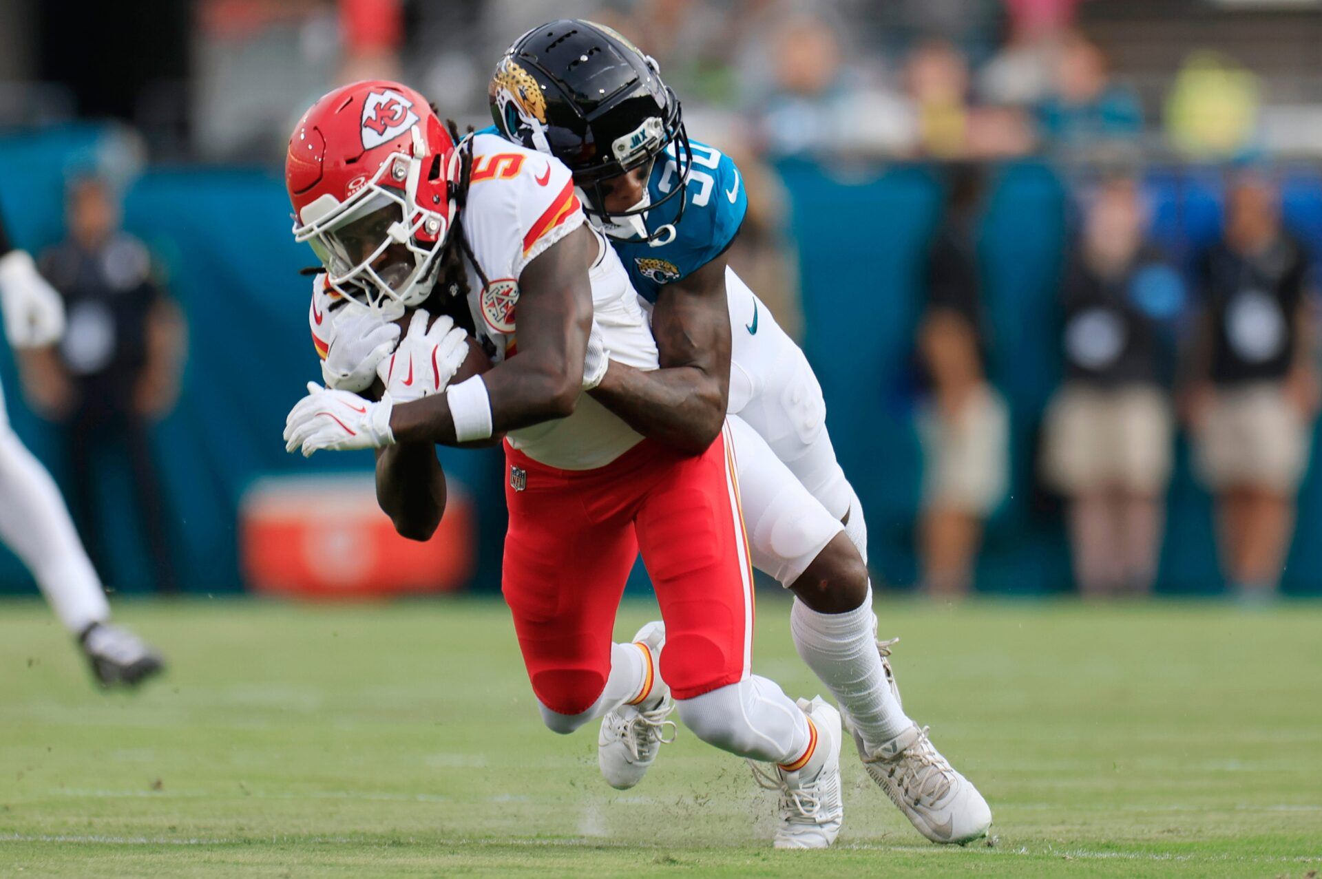 Jacksonville Jaguars cornerback Montaric Brown (30) tackles Kansas City Chiefs wide receiver Hollywood Brown (5) during the first quarter of a preseason NFL football game Saturday, Aug. 10, 2024 at EverBank Stadium in Jacksonville, Fla.