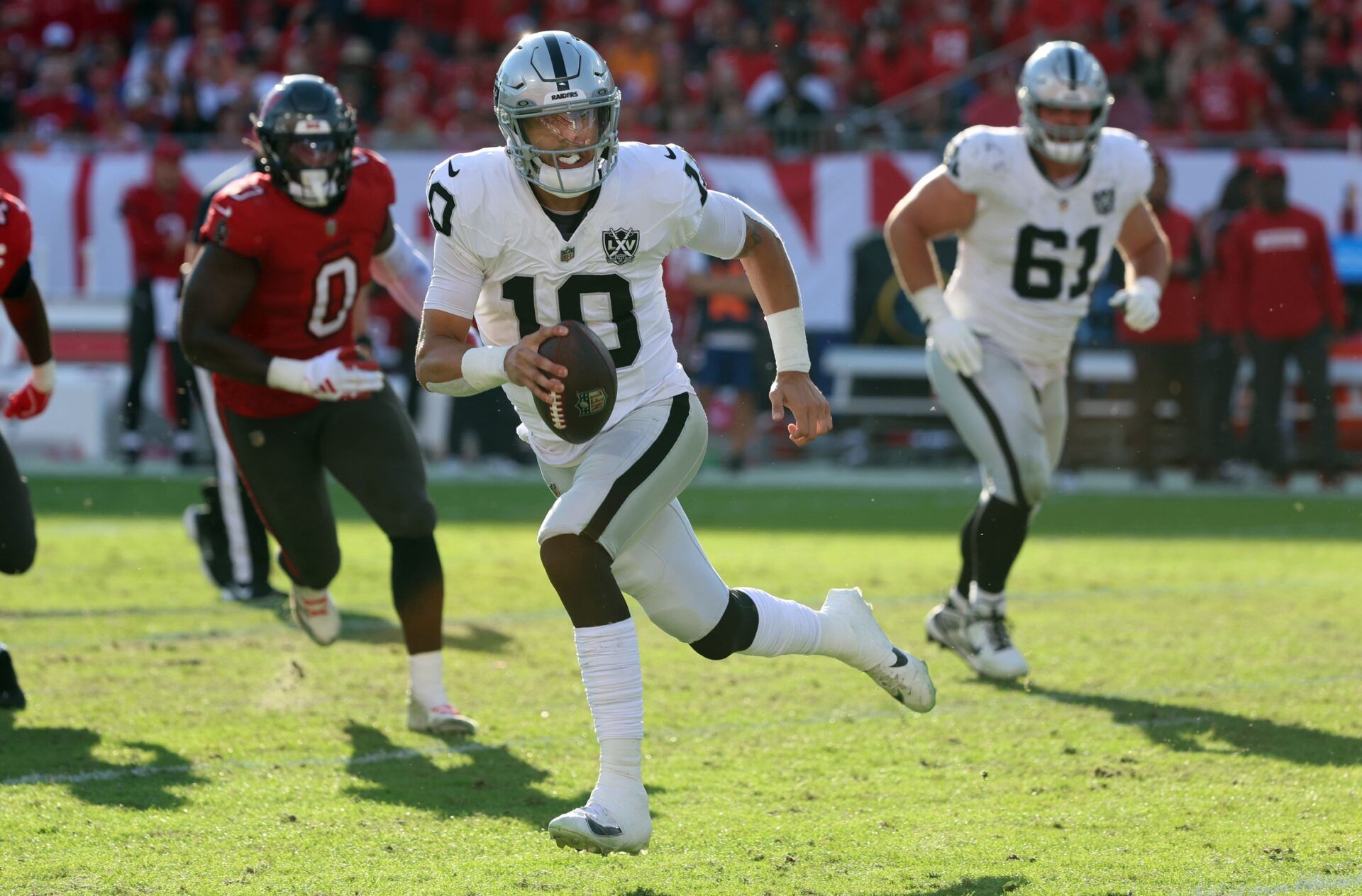 Las Vegas Raiders quarterback Desmond Ridder (10) runs with the ball against the Tampa Bay Buccaneers during the second half at Raymond James Stadium.