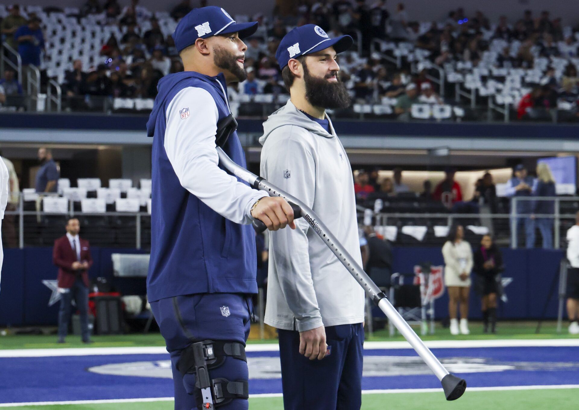 Dallas Cowboys quarterback Dak Prescott (left) stands on crutches before the game against the Houston Texans at AT&T Stadium.