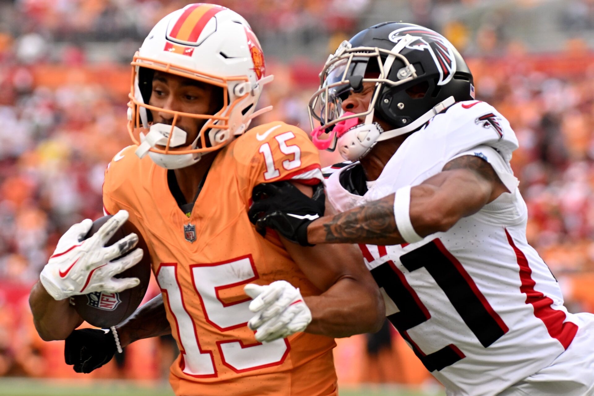 Oct 27, 2024; Tampa, Florida, USA; Tampa Bay Buccaneers wide receiver Jalen McMillan (15) gets tackled by Atlanta Falcons defensive back Mike Hughes (21) in the second half at Raymond James Stadium. Mandatory Credit: Jonathan Dyer-Imagn Images