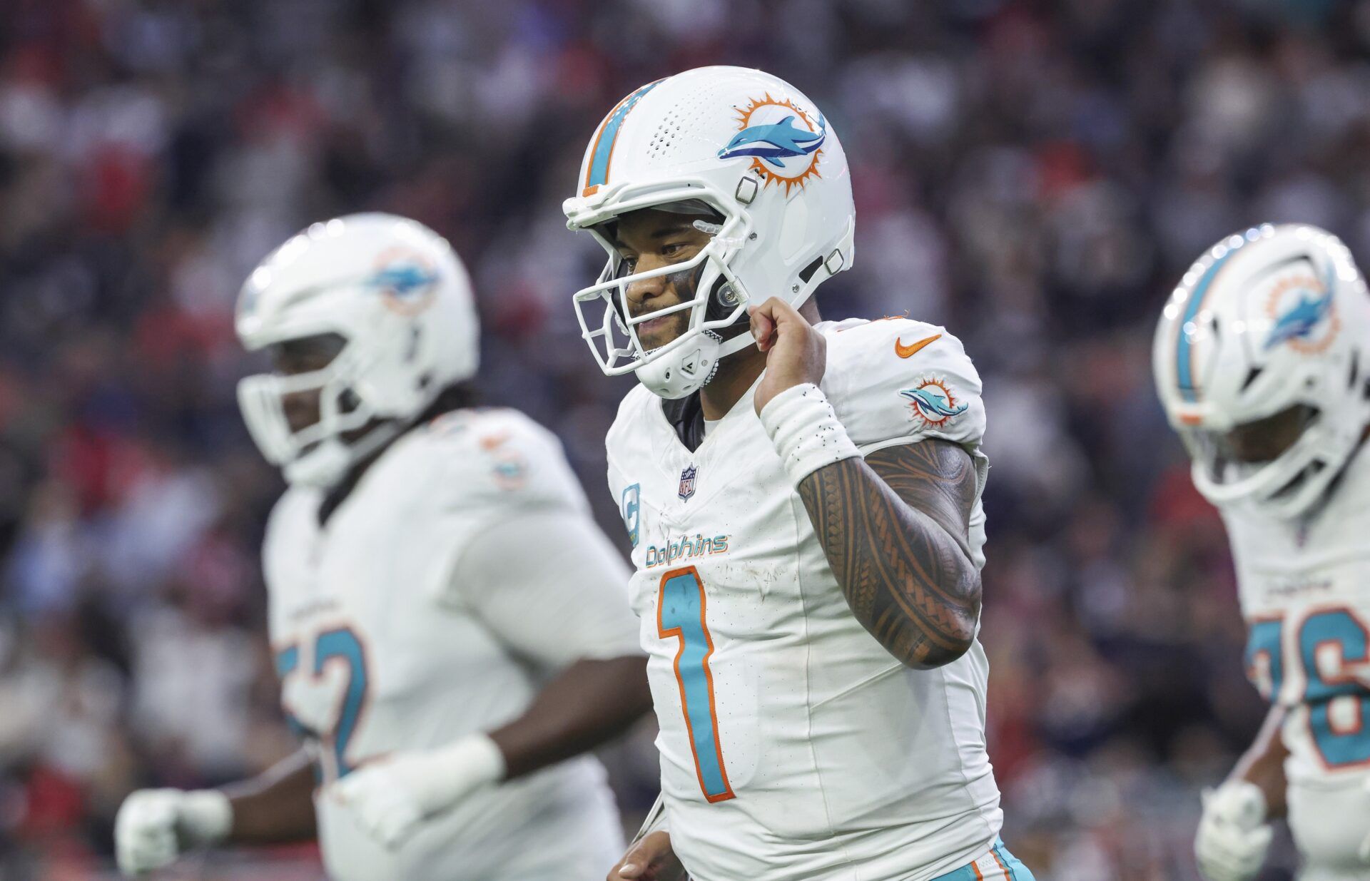 Miami Dolphins quarterback Tua Tagovailoa (1) jogs off the field after a play during the fourth quarter against the Houston Texans at NRG Stadium.