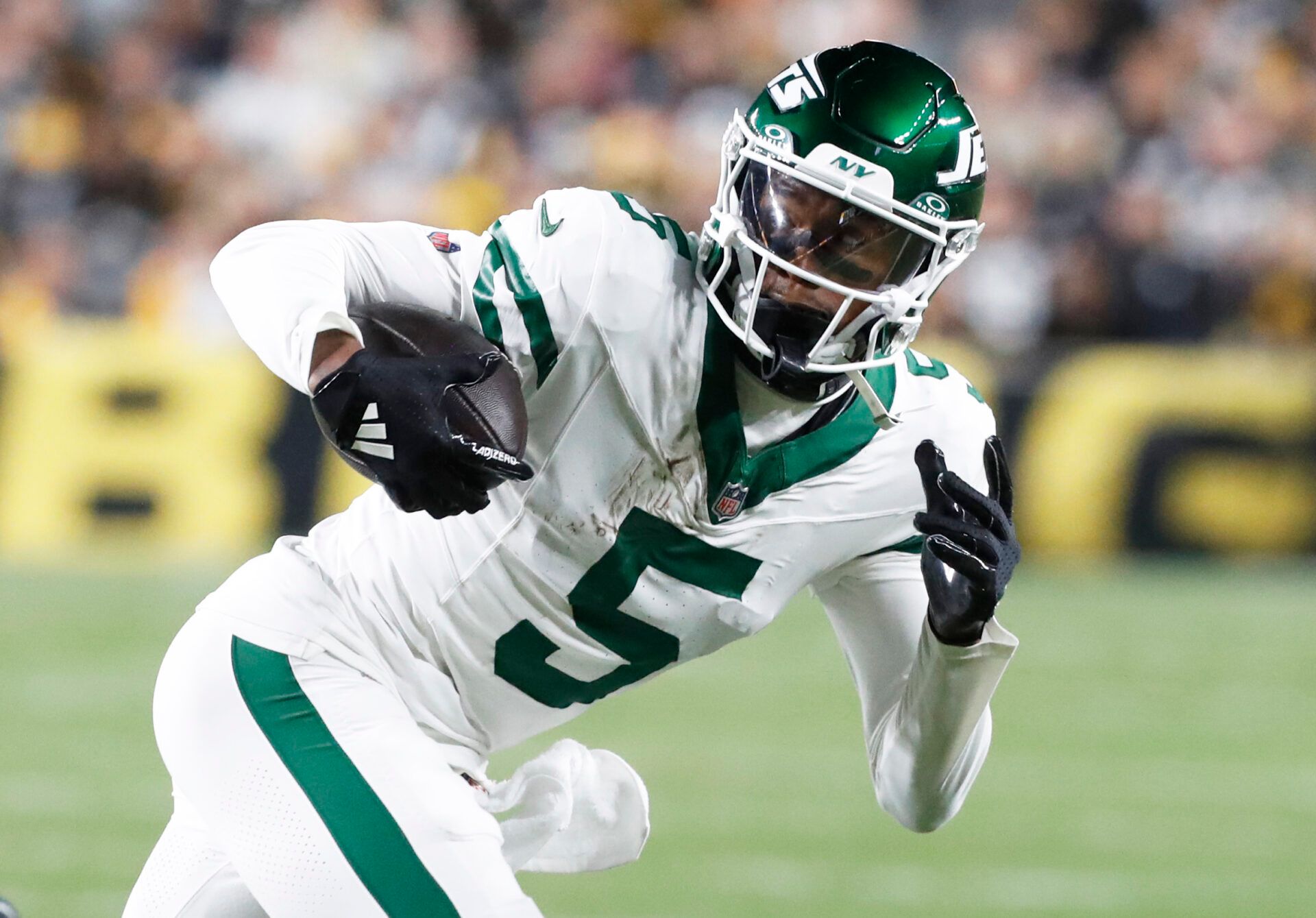 Oct 20, 2024; Pittsburgh, Pennsylvania, USA; New York Jets wide receiver Garrett Wilson (5) runs after a catch against the Pittsburgh Steelers during the first quarter at Acrisure Stadium. Mandatory Credit: Charles LeClaire-Imagn Images