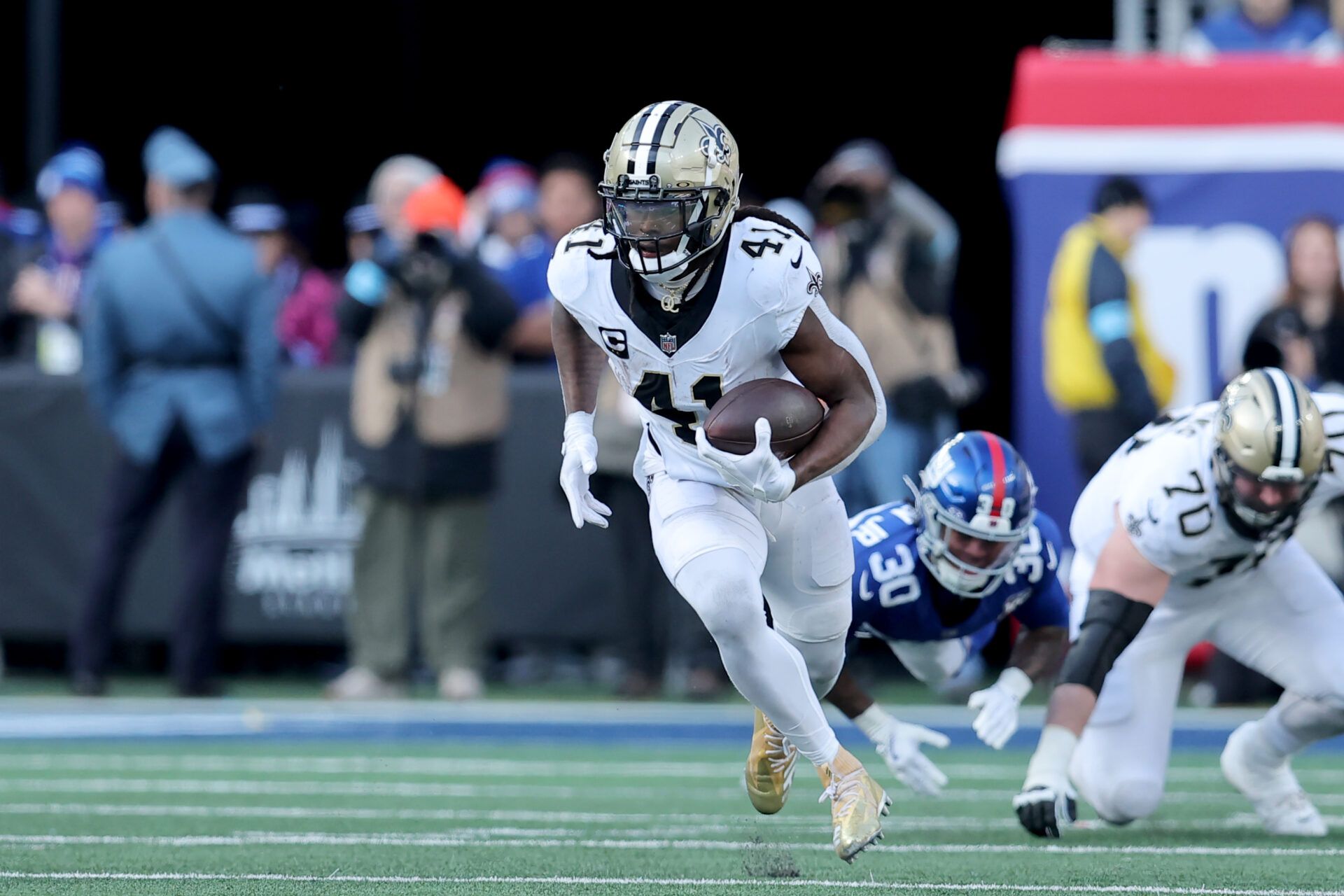 Dec 8, 2024; East Rutherford, New Jersey, USA; New Orleans Saints running back Alvin Kamara (41) runs with the ball against the New York Giants during the second quarter at MetLife Stadium. Mandatory Credit: Brad Penner-Imagn Images