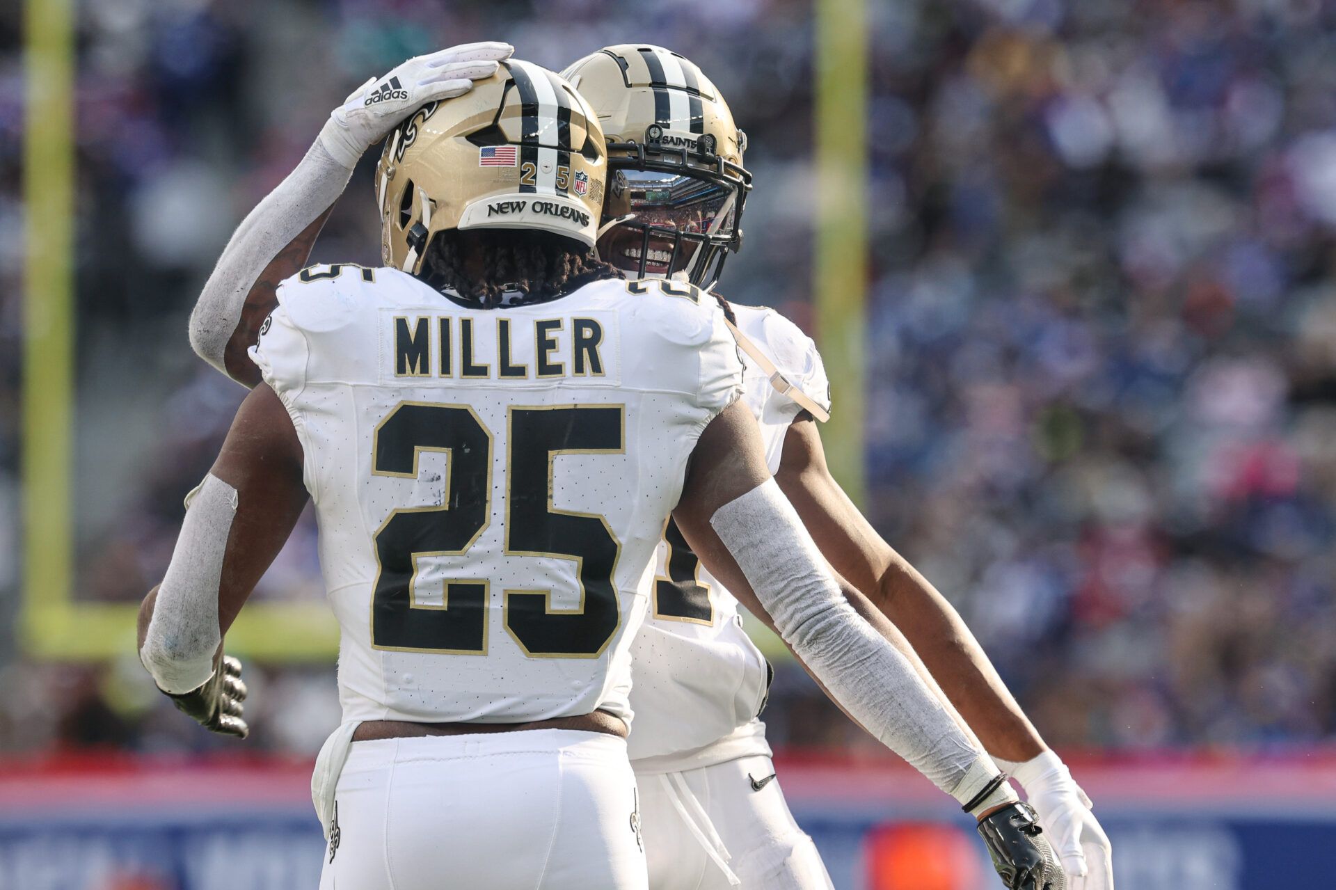 Dec 8, 2024; East Rutherford, New Jersey, USA; New Orleans Saints running back Kendre Miller (25) celebrates with running back Alvin Kamara (41) after a rushing touchdown during the first half against the New York Giants at MetLife Stadium. Mandatory Credit: Vincent Carchietta-Imagn Images