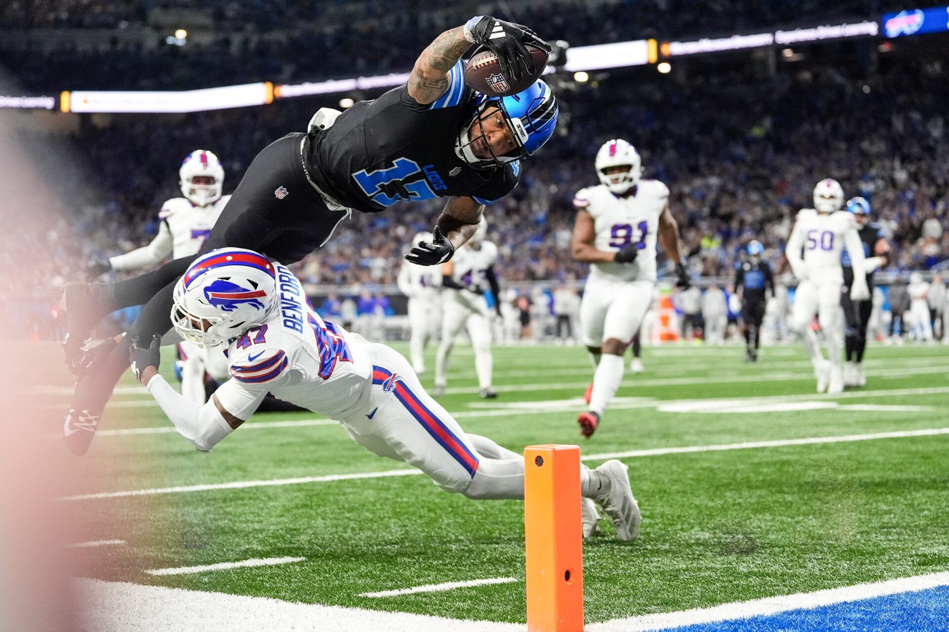 Detroit Lions wide receiver Tim Patrick (17) dives for a touchdown against Buffalo Bills cornerback Christian Benford (47) during the first half at Ford Field in Detroit on Sunday, Dec. 15, 2024.