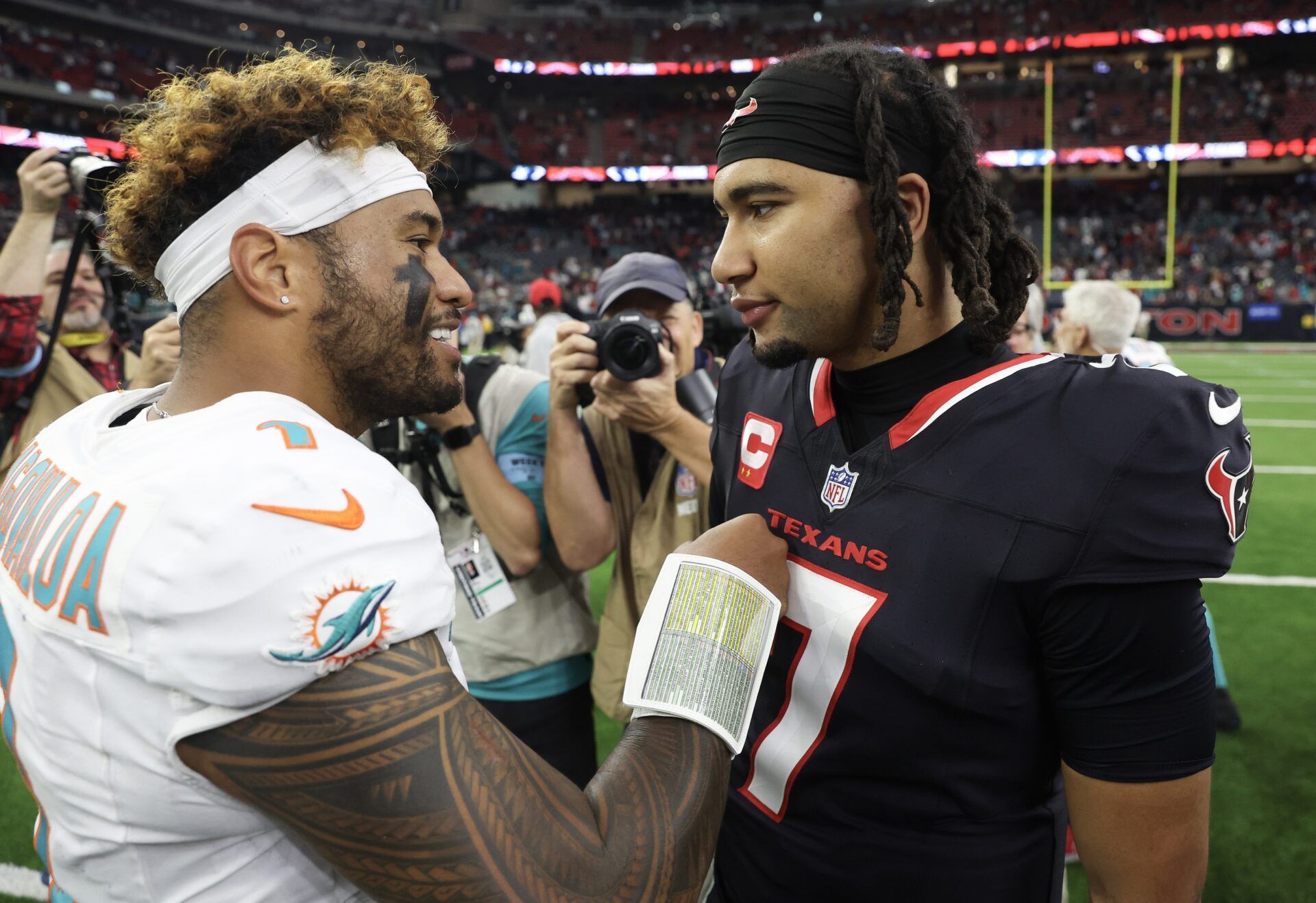 Miami Dolphins quarterback Tua Tagovailoa (1) and Houston Texans quarterback C.J. Stroud (7) talk after a game at NRG Stadium.