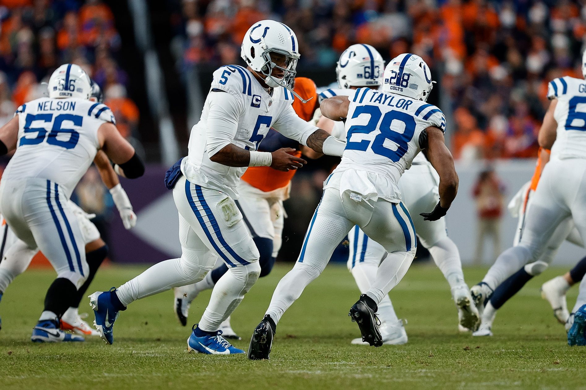 Indianapolis Colts quarterback Anthony Richardson (5) hands the ball off to running back Jonathan Taylor (28) in the third quarter against the Denver Broncos at Empower Field at Mile High.