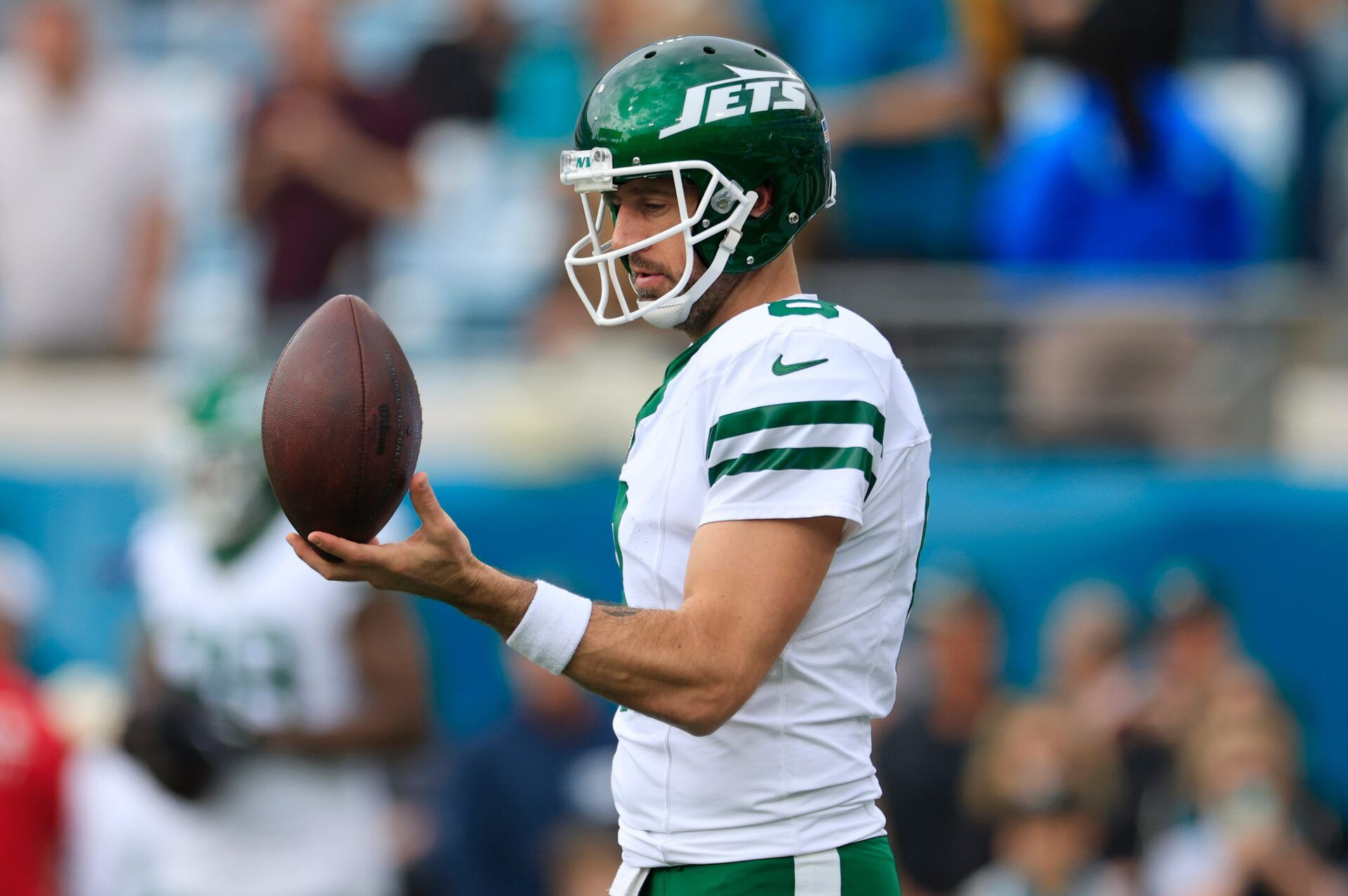 New York Jets quarterback Aaron Rodgers (8) balances a ball before an NFL football matchup Sunday, Dec. 15, 2024 at EverBank Stadium in Jacksonville, Fla.