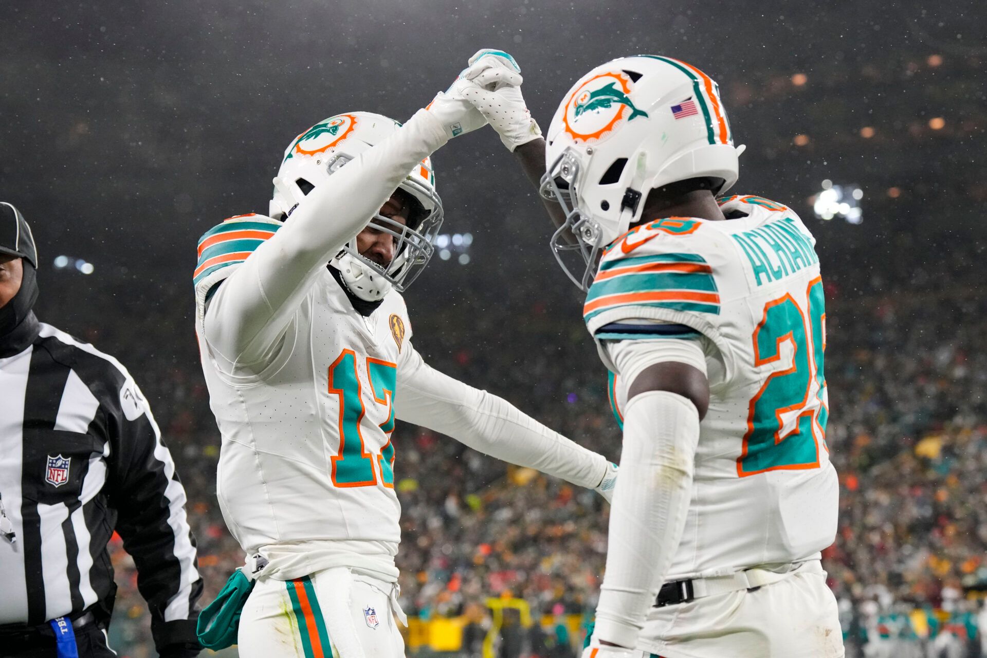 Nov 28, 2024; Green Bay, Wisconsin, USA; Miami Dolphins wide receiver Jaylen Waddle (17) celebrates with running back De'Von Achane (28) following a two point conversion during the third quarter against the Green Bay Packers at Lambeau Field. Mandatory Credit: Jeff Hanisch-Imagn Images