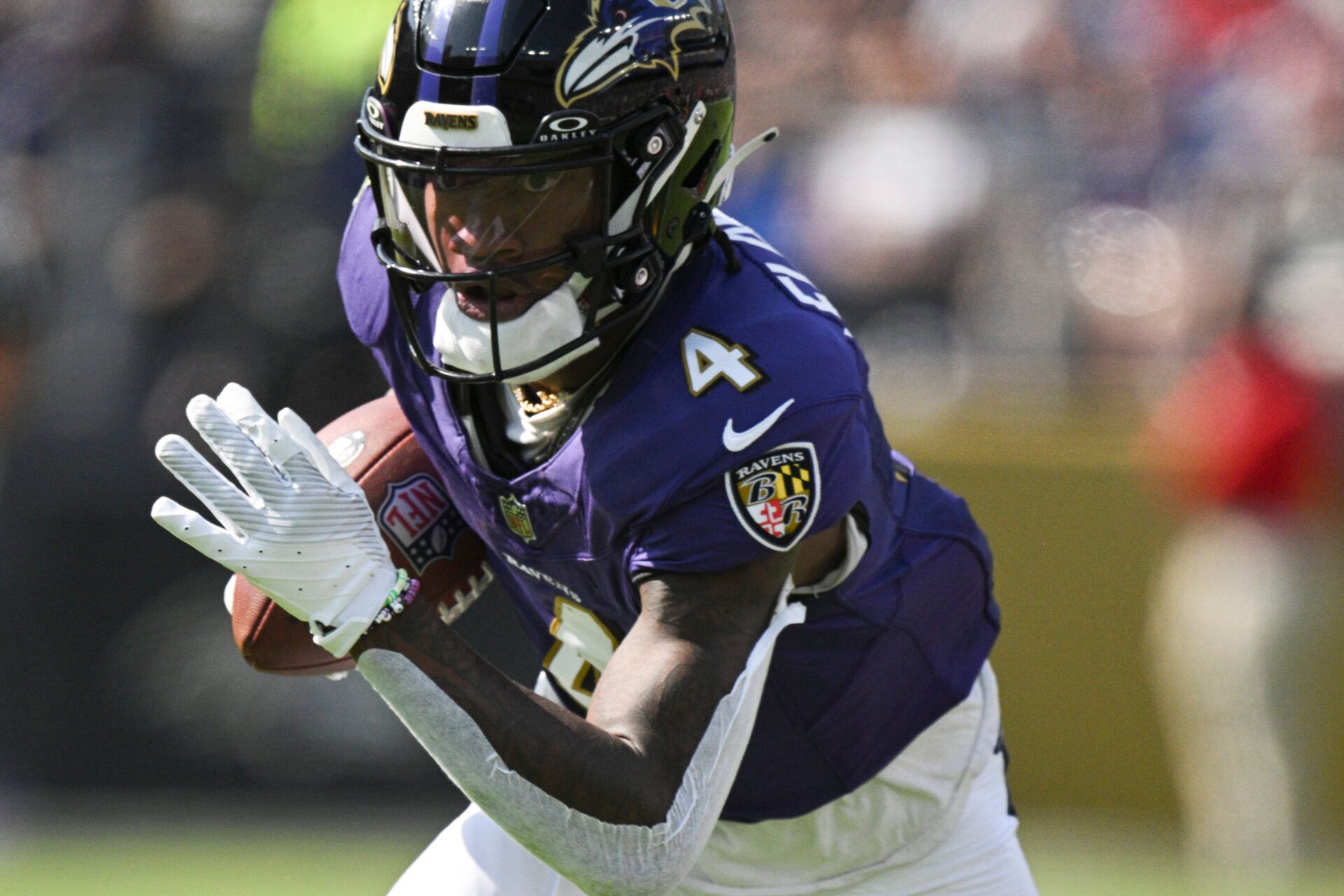 Oct 13, 2024; Baltimore, Maryland, USA; Baltimore Ravens wide receiver Zay Flowers (4) runs after a catch during the first half against the Washington Commanders at M&T Bank Stadium. Mandatory Credit: Tommy Gilligan-Imagn Images