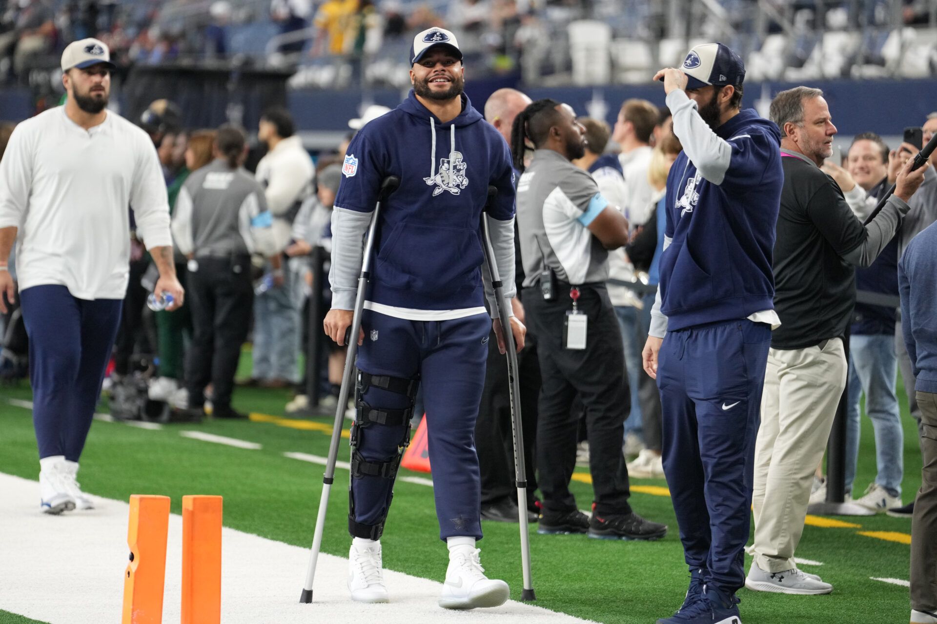 Nov 28, 2024; Arlington, Texas, USA; Dallas Cowboys quarterback Dak Prescott (left) stands on crutches before the game against the New York Giants at AT&T Stadium. Mandatory Credit: Chris Jones-Imagn Images