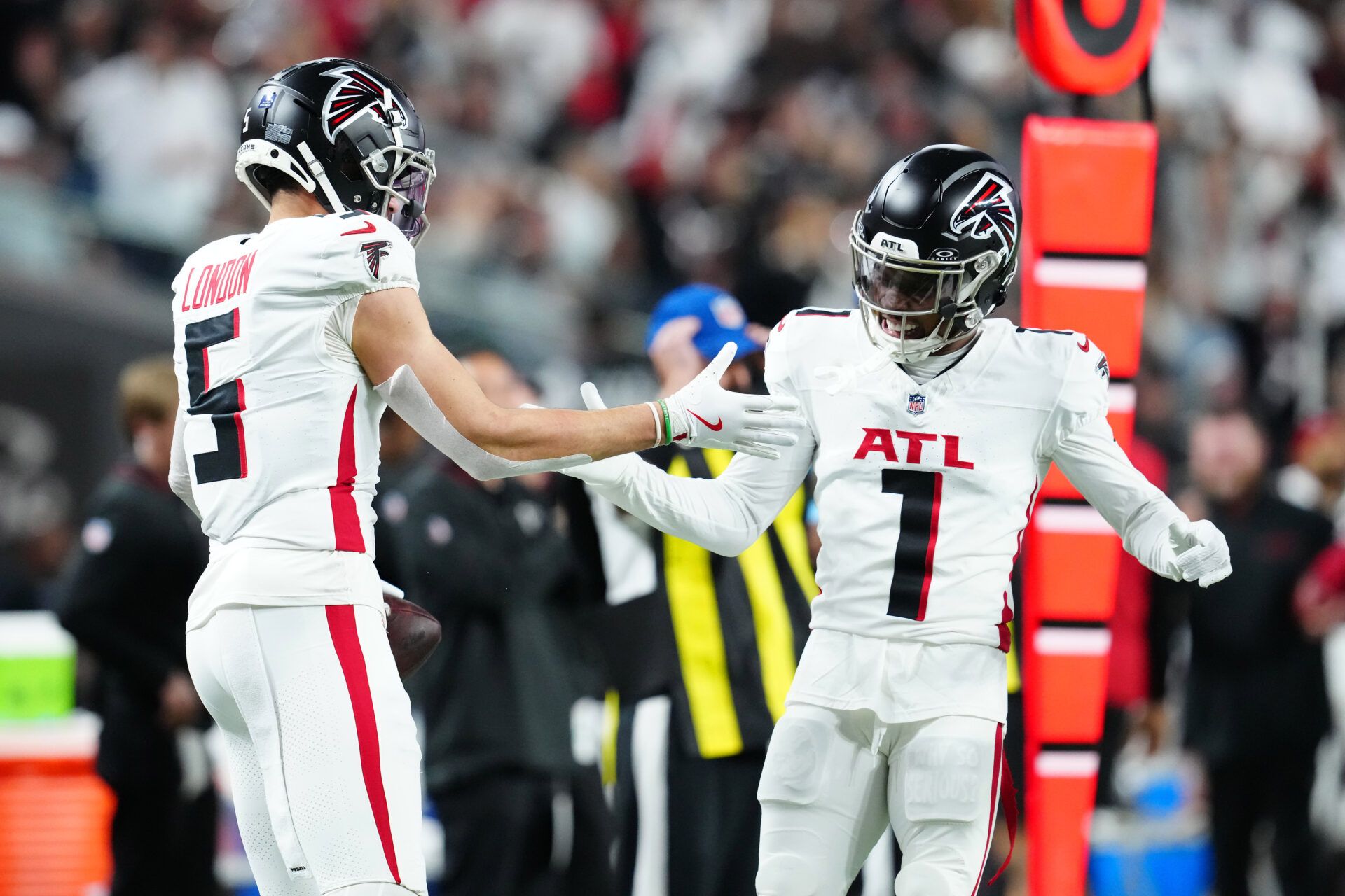 Dec 16, 2024; Paradise, Nevada, USA; Atlanta Falcons wide receiver Drake London (5) celebrates with wide receiver Darnell Mooney (1) after scoring a touchdown against the Las Vegas Raiders during the first quarter at Allegiant Stadium. Mandatory Credit: Stephen R. Sylvanie-Imagn Images