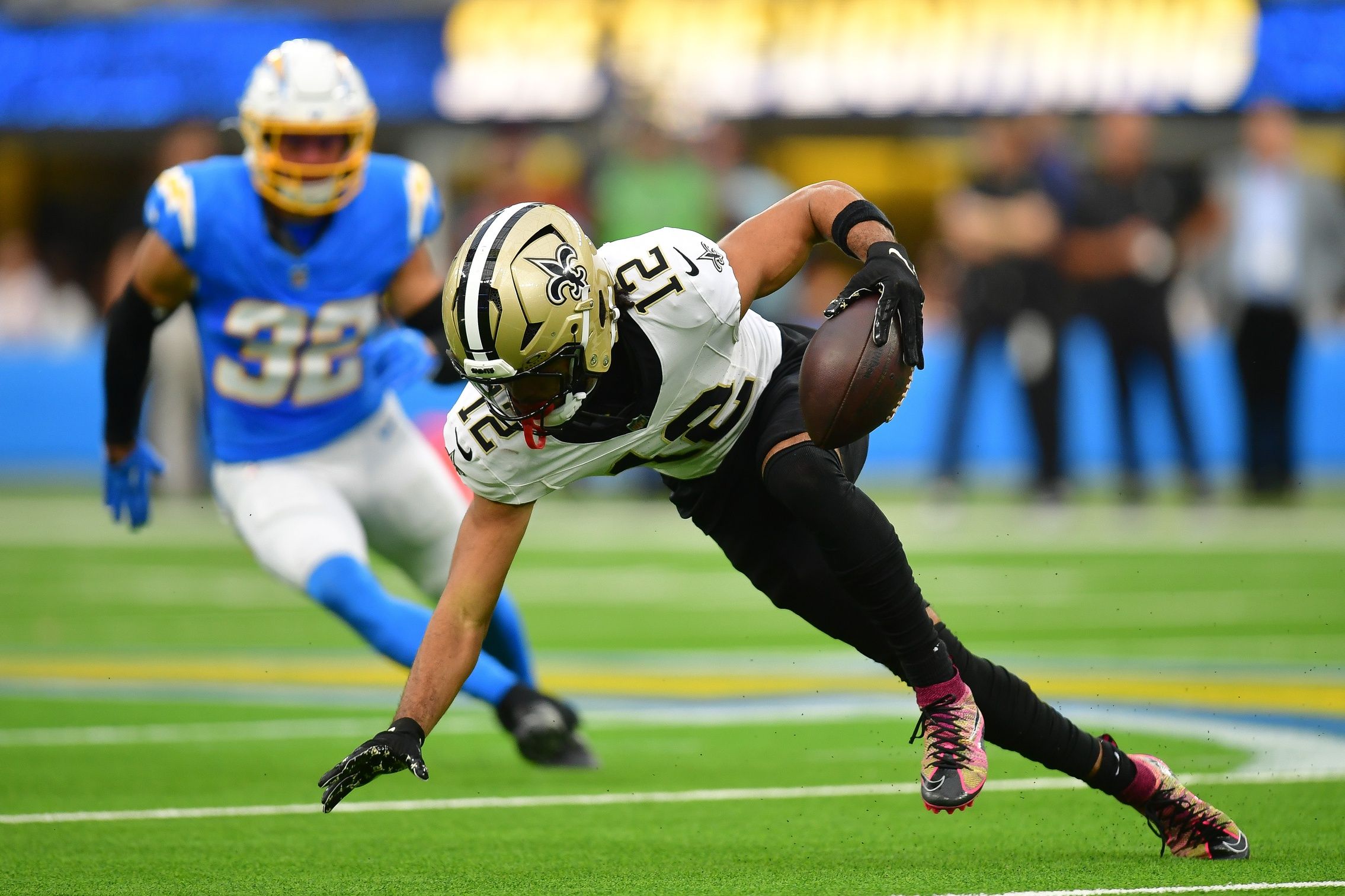 New Orleans Saints wide receiver Chris Olave (12) runs the ball against the Los Angeles Chargers during the second half at SoFi Stadium.