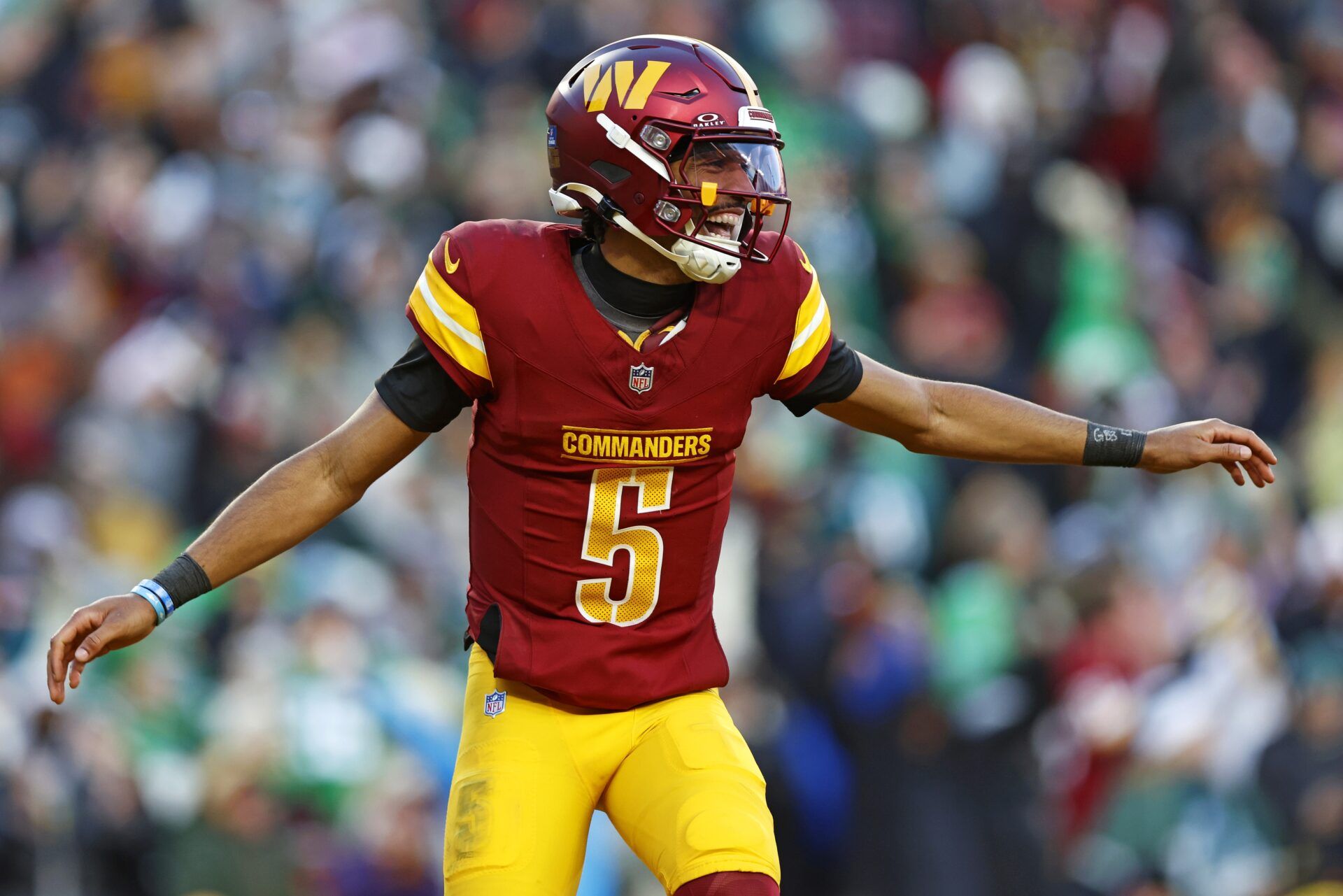 Washington Commanders quarterback Jayden Daniels (5) celebrates after throwing a touchdown during the fourth quarter against the Philadelphia Eagles at Northwest Stadium.