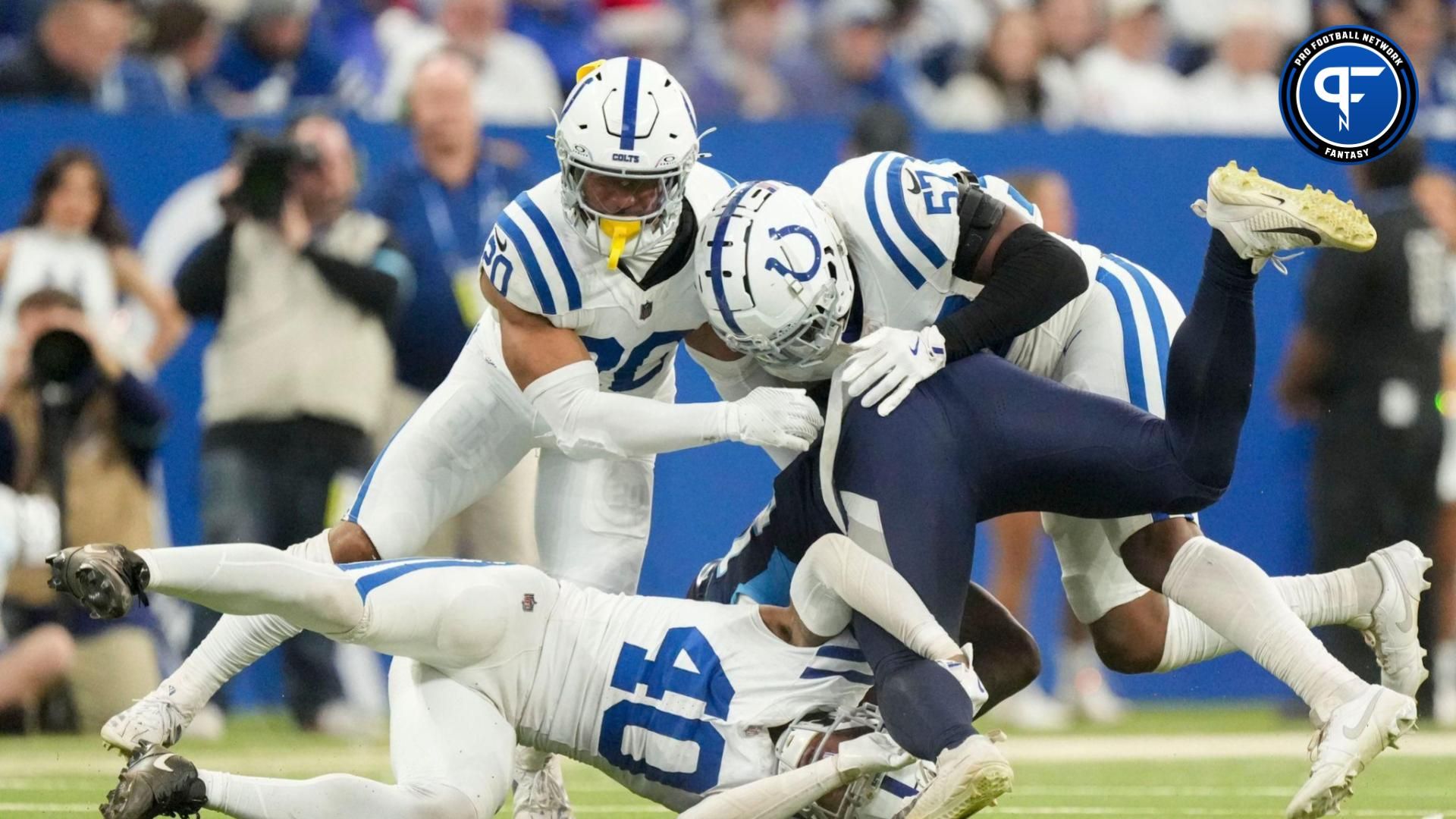 Tennessee Titans tight end Chig Okonkwo (85) is tackled by Indianapolis Colts safety Nick Cross (20), Indianapolis Colts linebacker Jaylon Carlies (57) and Indianapolis Colts cornerback Jaylon Jones (40) on Sunday, Dec. 22, 2024, during a game against the Tennessee Titans at Lucas Oil Stadium in Indianapolis.