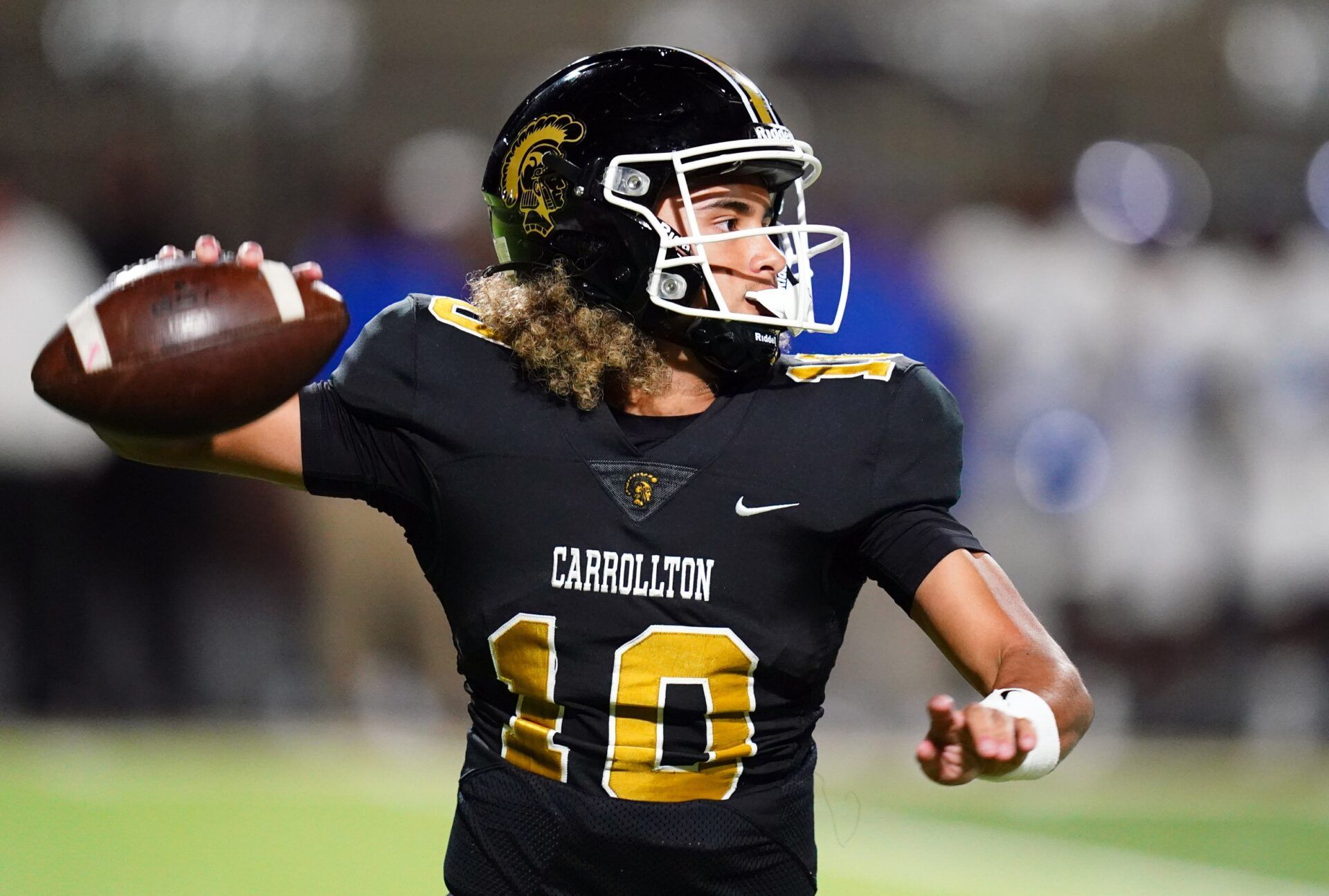 Carrollton Trojans quarterback Julian Lewis (10) drops back to pass against the Westlake Lions during the first half at Grisham Stadium. The 15-year-old Carrollton High student has already committed to playing for the University of Southern California Trojans and has been considered one of the top high school quarterback prospects.