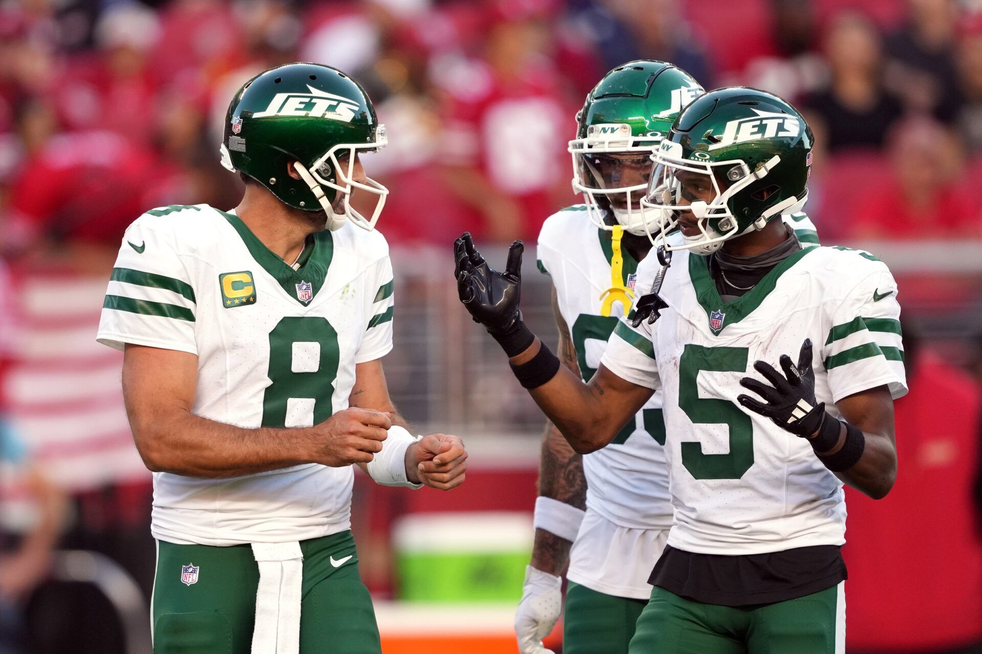 New York Jets quarterback Aaron Rodgers (8) and wide receiver Garrett Wilson (5) talk on the field during the second quarter against the San Francisco 49ers at Levi's Stadium.