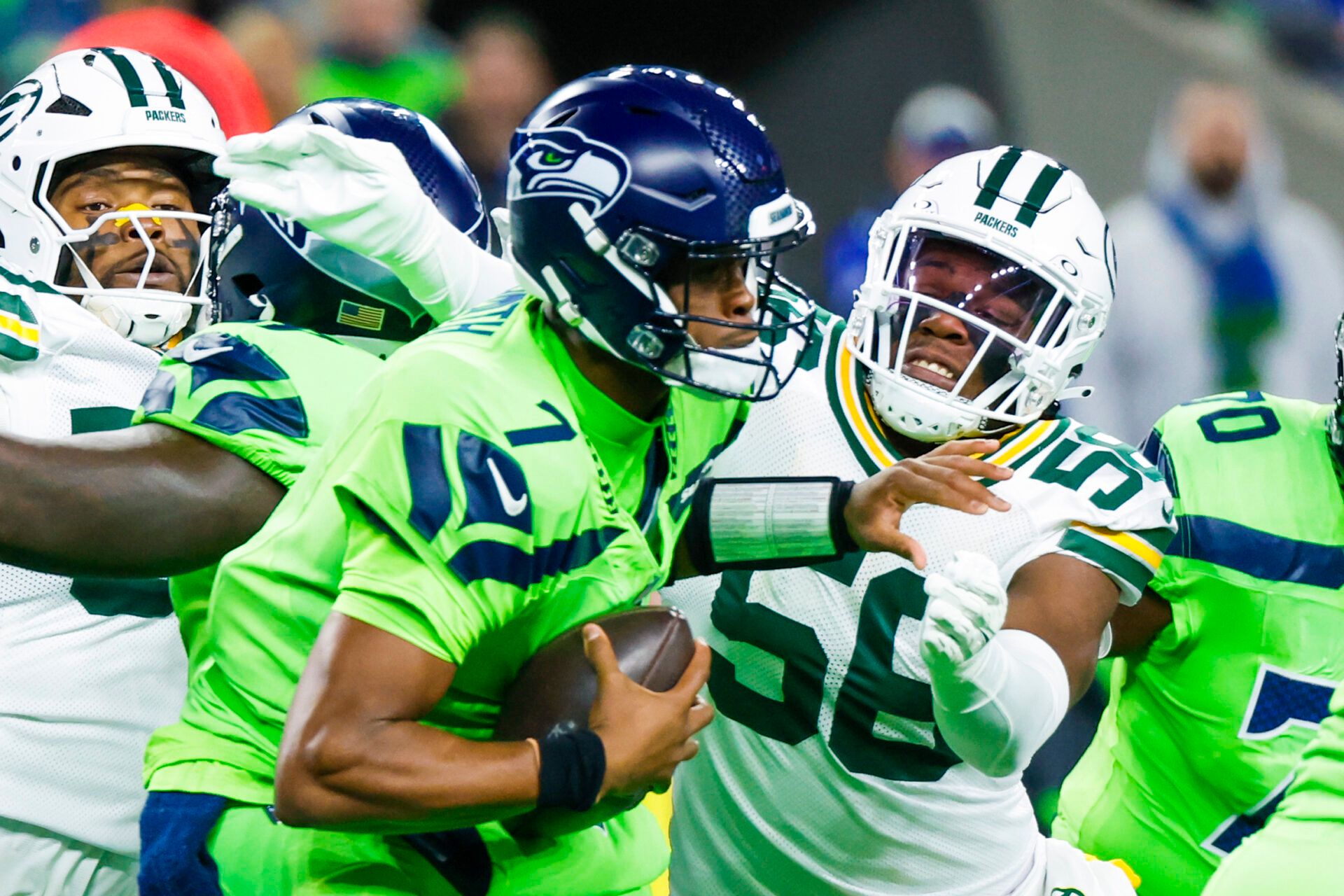 Dec 15, 2024; Seattle, Washington, USA; Green Bay Packers linebacker Edgerrin Cooper (56) sacks Seattle Seahawks quarterback Geno Smith (7) during the first quarter at Lumen Field. Mandatory Credit: Joe Nicholson-Imagn Images