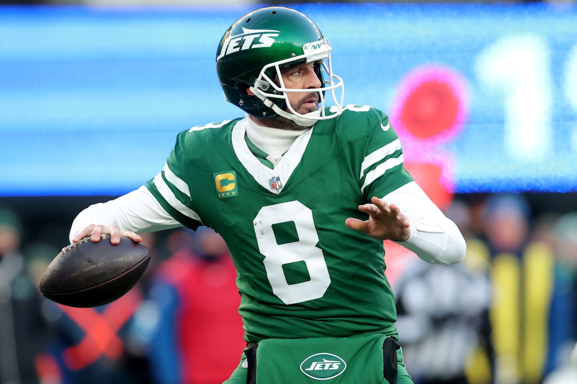 Dec 22, 2024; East Rutherford, New Jersey, USA; New York Jets quarterback Aaron Rodgers (8) drops back to pass against the Los Angeles Rams during the fourth quarter at MetLife Stadium. Mandatory Credit: Brad Penner-Imagn Images