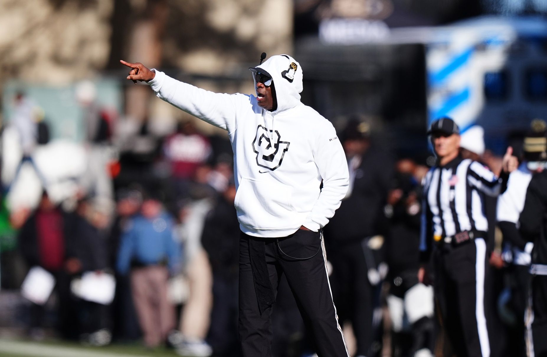 Colorado Buffaloes head coach Deion Sanders calls out in the second quarter against the Oklahoma State Cowboys at Folsom Field.