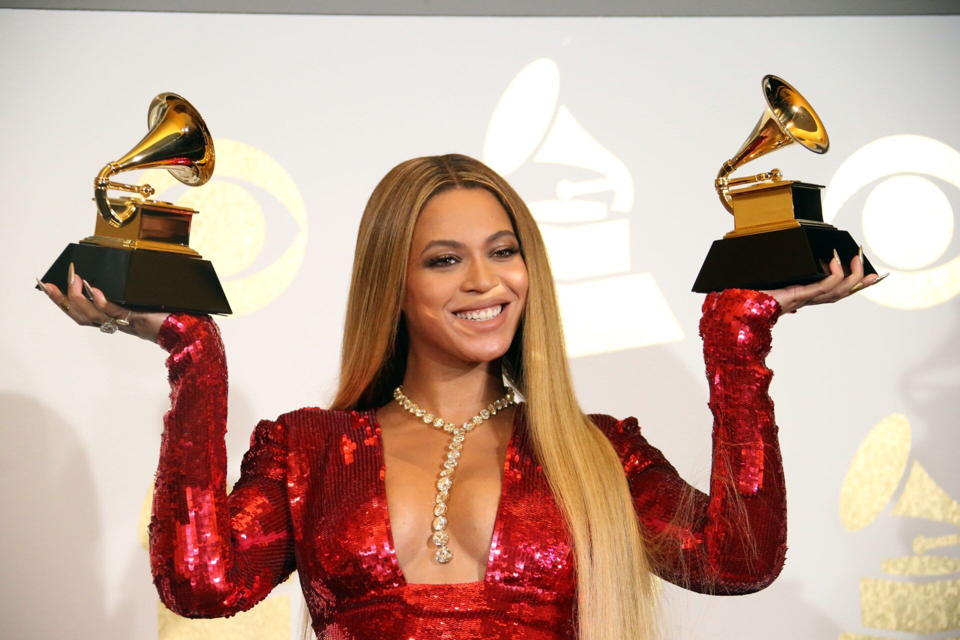 Beyonce Knowles poses in the photo room with her awards during the 59th Annual GRAMMY Awards at Staples Center.