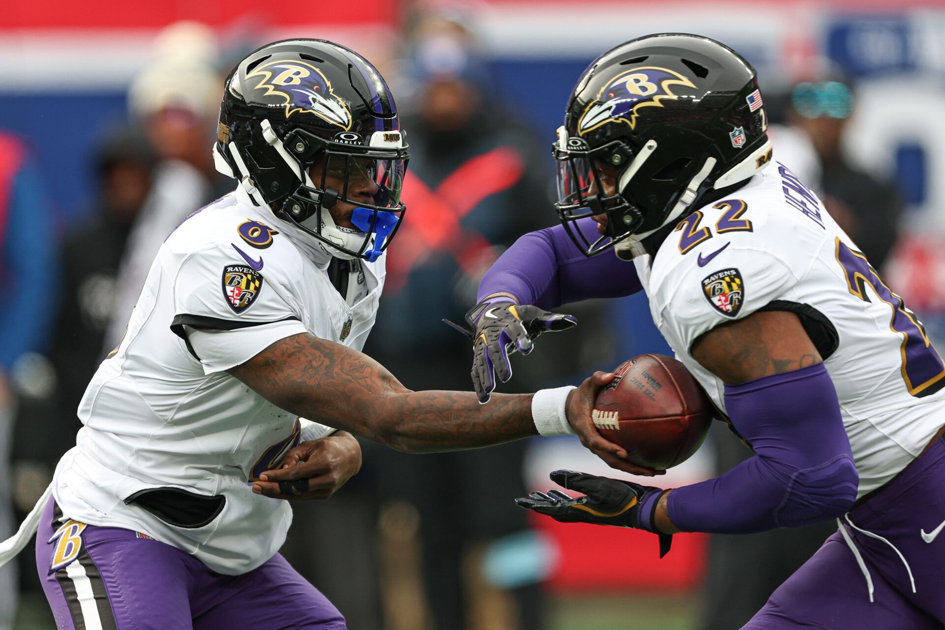 Dec 15, 2024; East Rutherford, New Jersey, USA; Baltimore Ravens quarterback Lamar Jackson (8) hands off to running back Derrick Henry (22) during the first quarter at MetLife Stadium. Mandatory Credit: Vincent Carchietta-Imagn Images