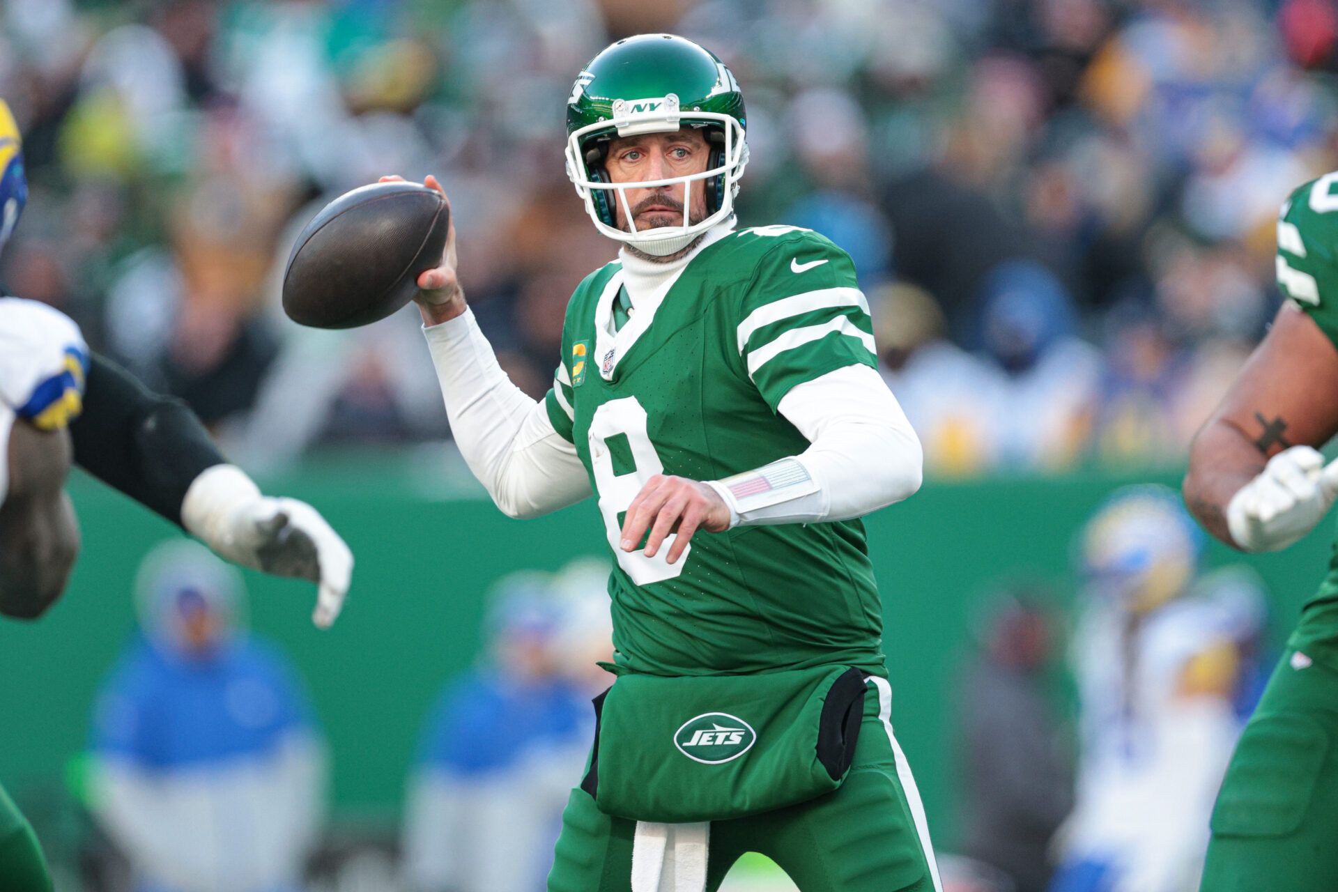 Dec 22, 2024; East Rutherford, New Jersey, USA; New York Jets quarterback Aaron Rodgers (8) throws the ball during the second half against the Los Angeles Rams at MetLife Stadium. Mandatory Credit: Vincent Carchietta-Imagn Images