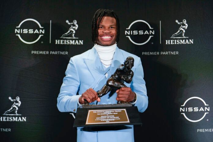 Dec 14, 2024; New York, NY, USA; Colorado Buffaloes wide receiver/cornerback Travis Hunter poses for a photo after winning the Heisman Trophy award during the 2024 Heisman Trophy Presentation. Mandatory Credit: Lucas Boland-Imagn Images