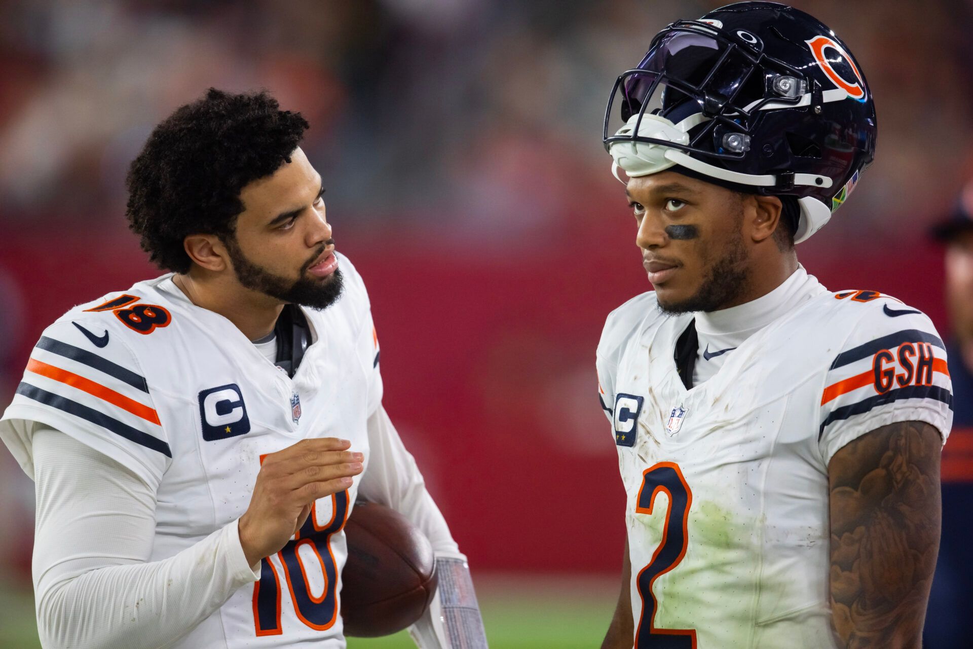 Nov 3, 2024; Glendale, Arizona, USA; Chicago Bears quarterback Caleb Williams (18) talks with wide receiver DJ Moore (2) against the Arizona Cardinals at State Farm Stadium. Mandatory Credit: Mark J. Rebilas-Imagn Images