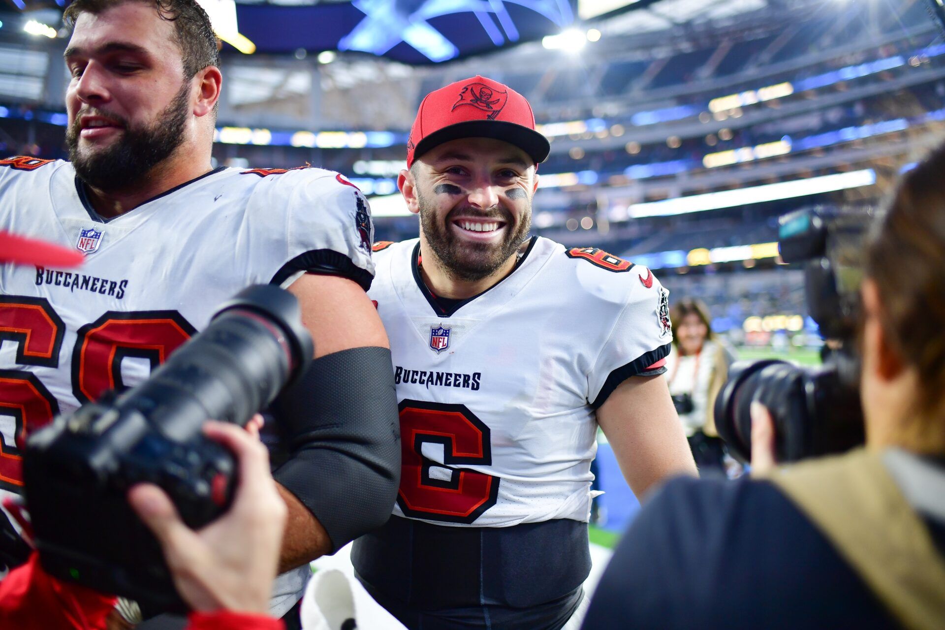 Tampa Bay Buccaneers guard Ben Bredeson (68) and quarterback Baker Mayfield (6) celebrate the victory against the Los Angeles Chargers at SoFi Stadium.