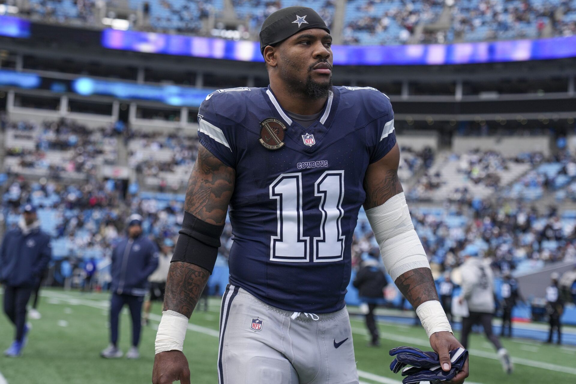 Dallas Cowboys linebacker Micah Parsons (11) walks onto the field during the first quarter against the Carolina Panthers at Bank of America Stadium.