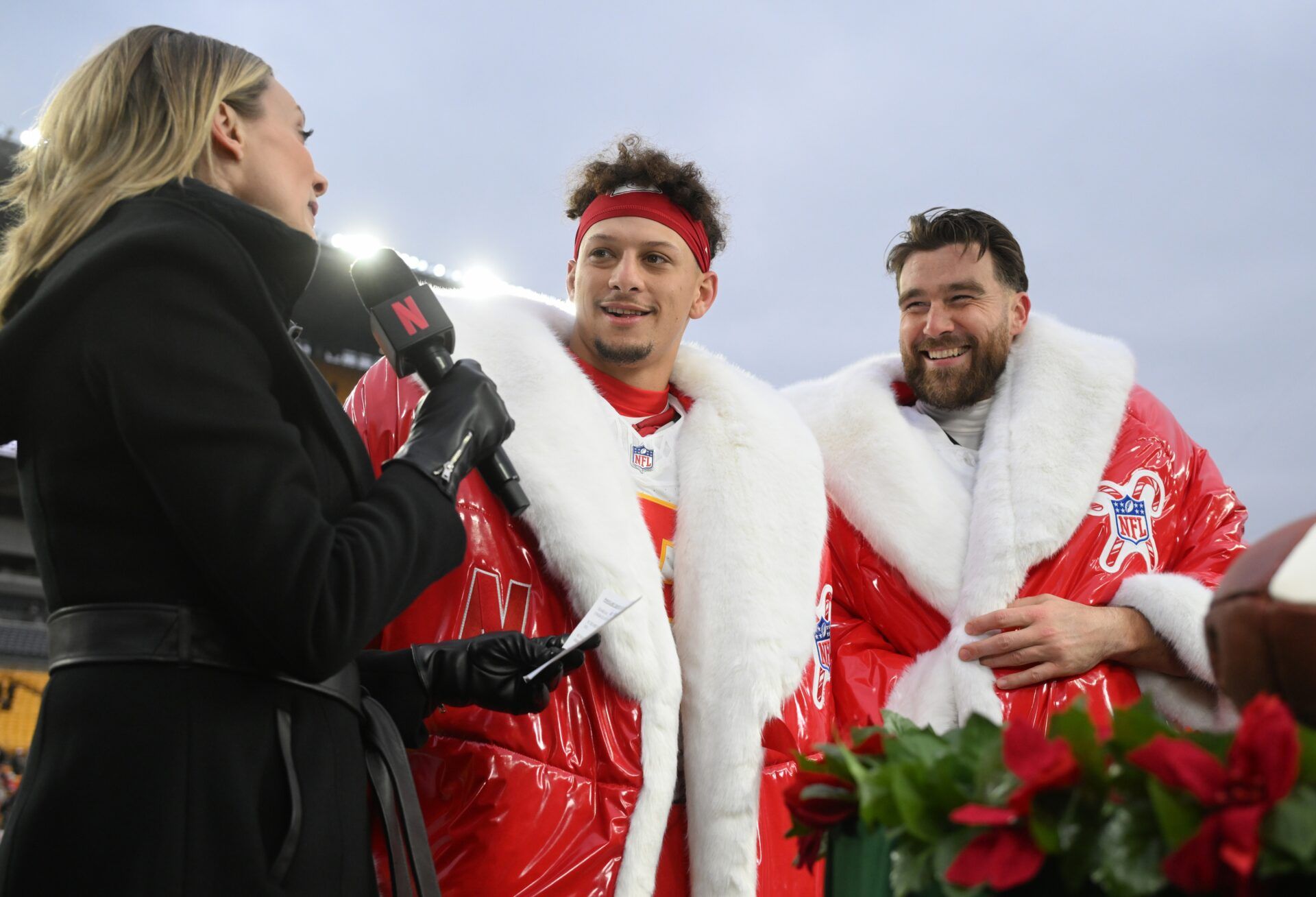 Kansas City Chiefs quarterback Patrick Mahomes (15) and tight end Travis Kelce (87) are interviewed by Netflix reporter Stacey Dales following their win against the Pittsburgh Steelers at Acrisure Stadium.