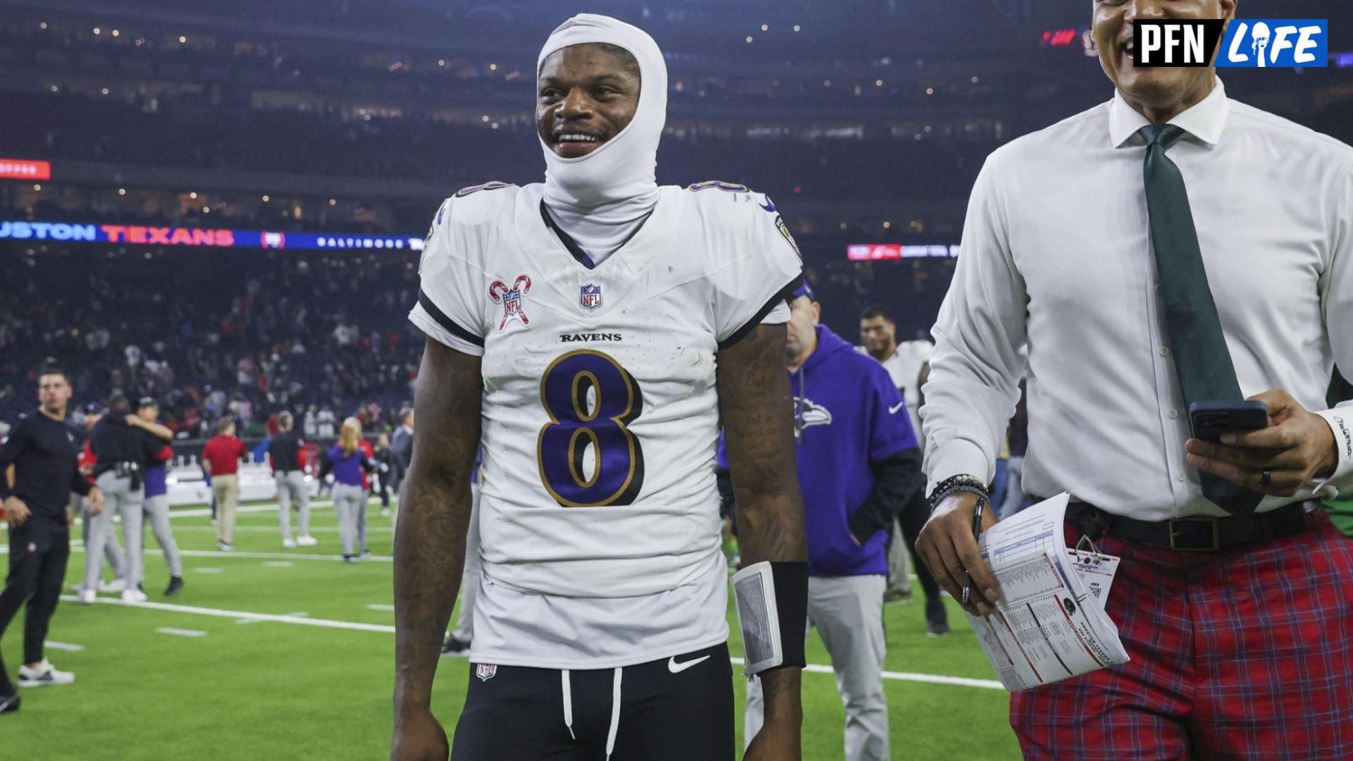 Baltimore Ravens quarterback Lamar Jackson (8) smiles while walking off the field after the game against the Houston Texans at NRG Stadium.