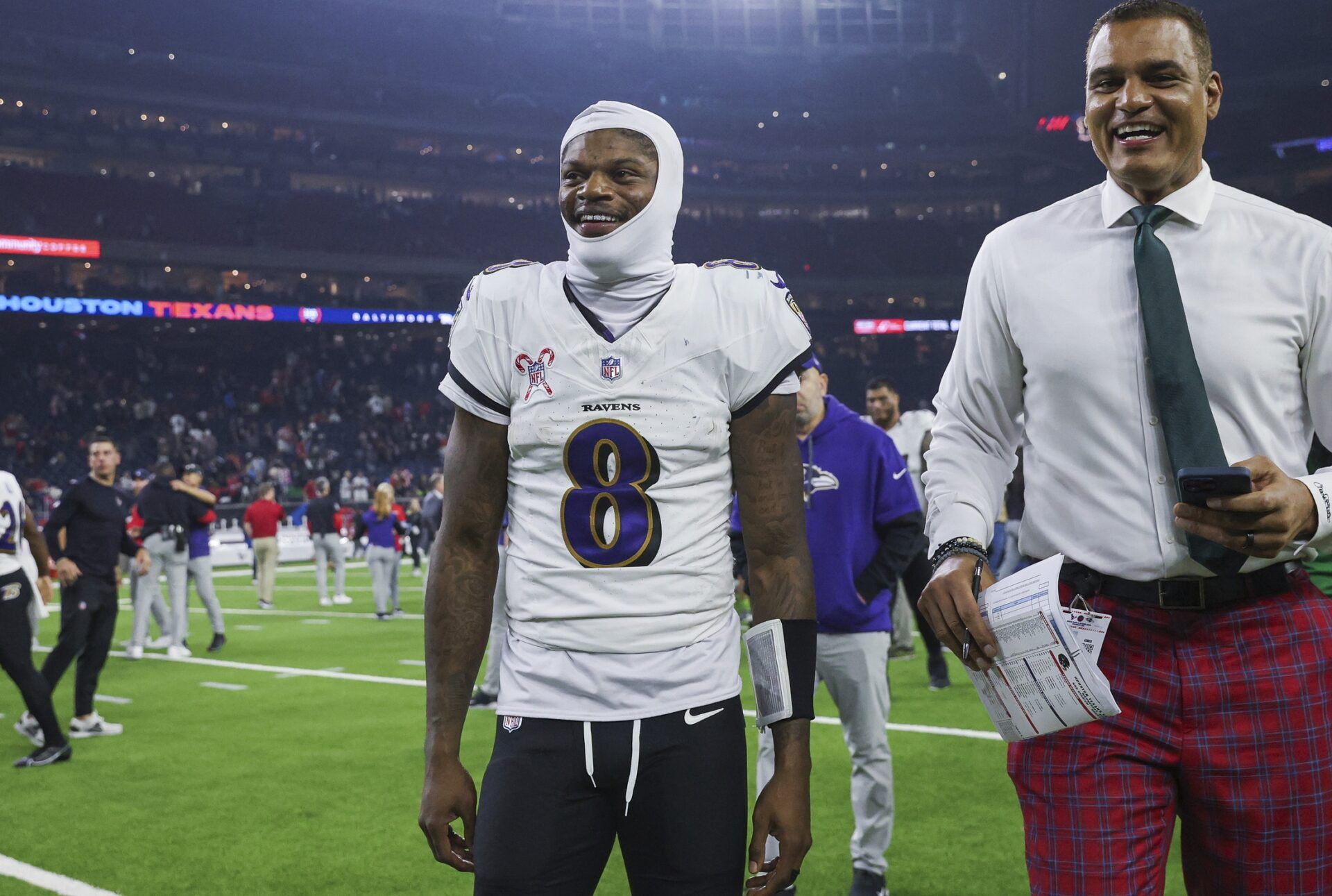 Baltimore Ravens quarterback Lamar Jackson (8) smiles while walking off the field after the game against the Houston Texans at NRG Stadium.