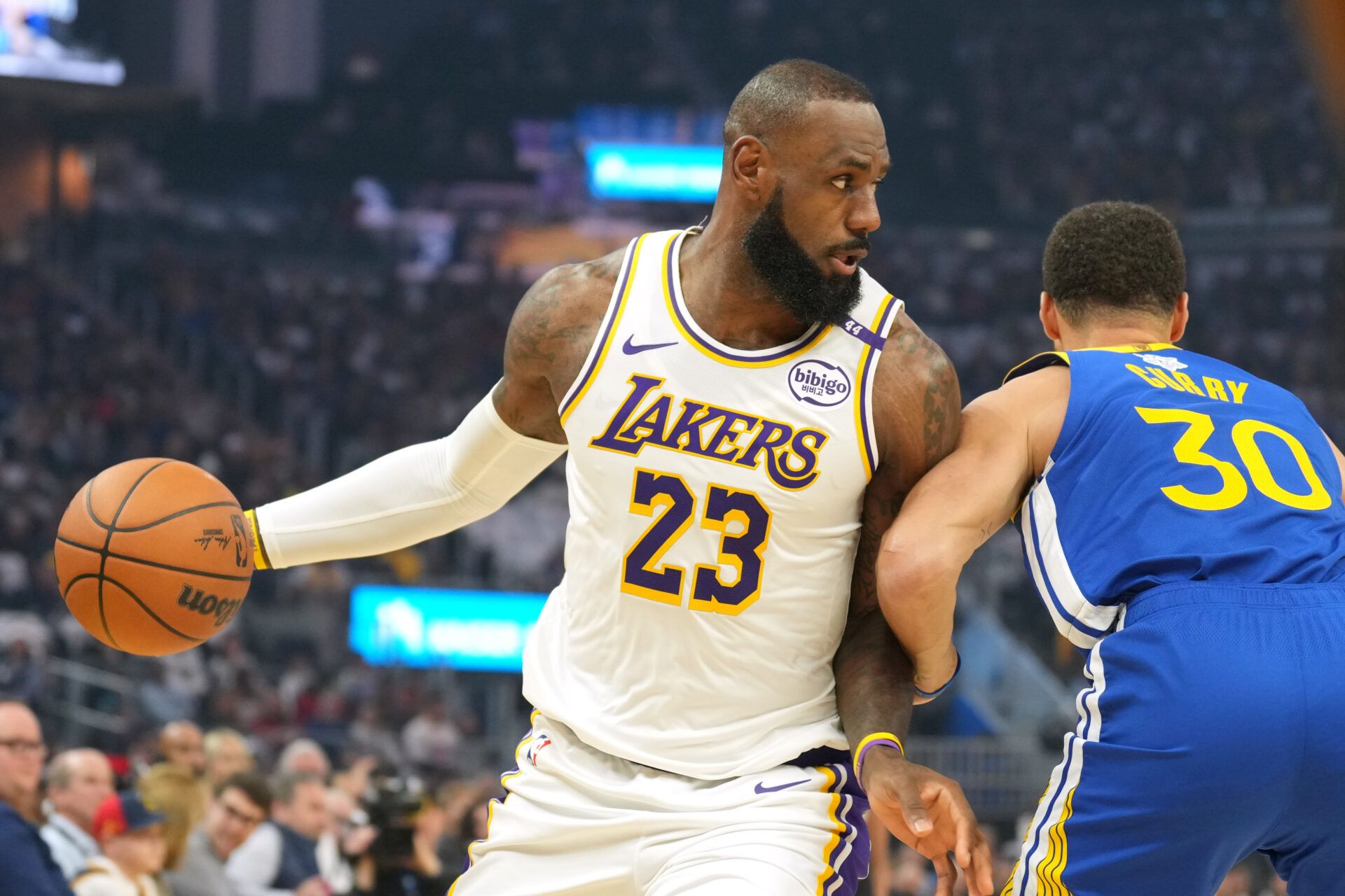 Dec 25, 2024; San Francisco, California, USA; Los Angeles Lakers forward LeBron James (23) dribbles against Golden State Warriors guard Stephen Curry (30) during the first quarter at Chase Center. Mandatory Credit: Darren Yamashita-Imagn Images