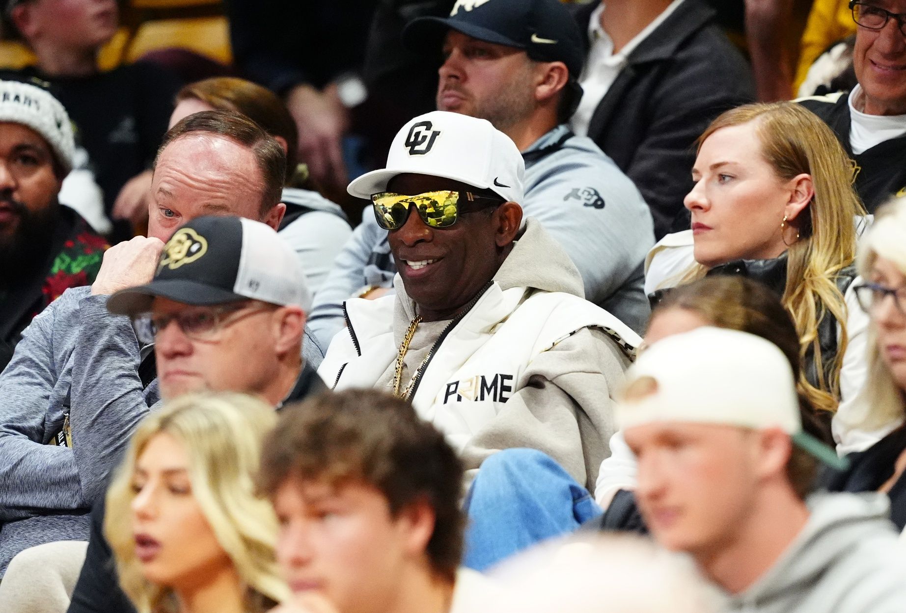 Colorado Buffaloes head football coach Deion Sanders (center) watches the Colorado Buffaloes basketball team take on the Bellarmine Knights at CU Events Center.