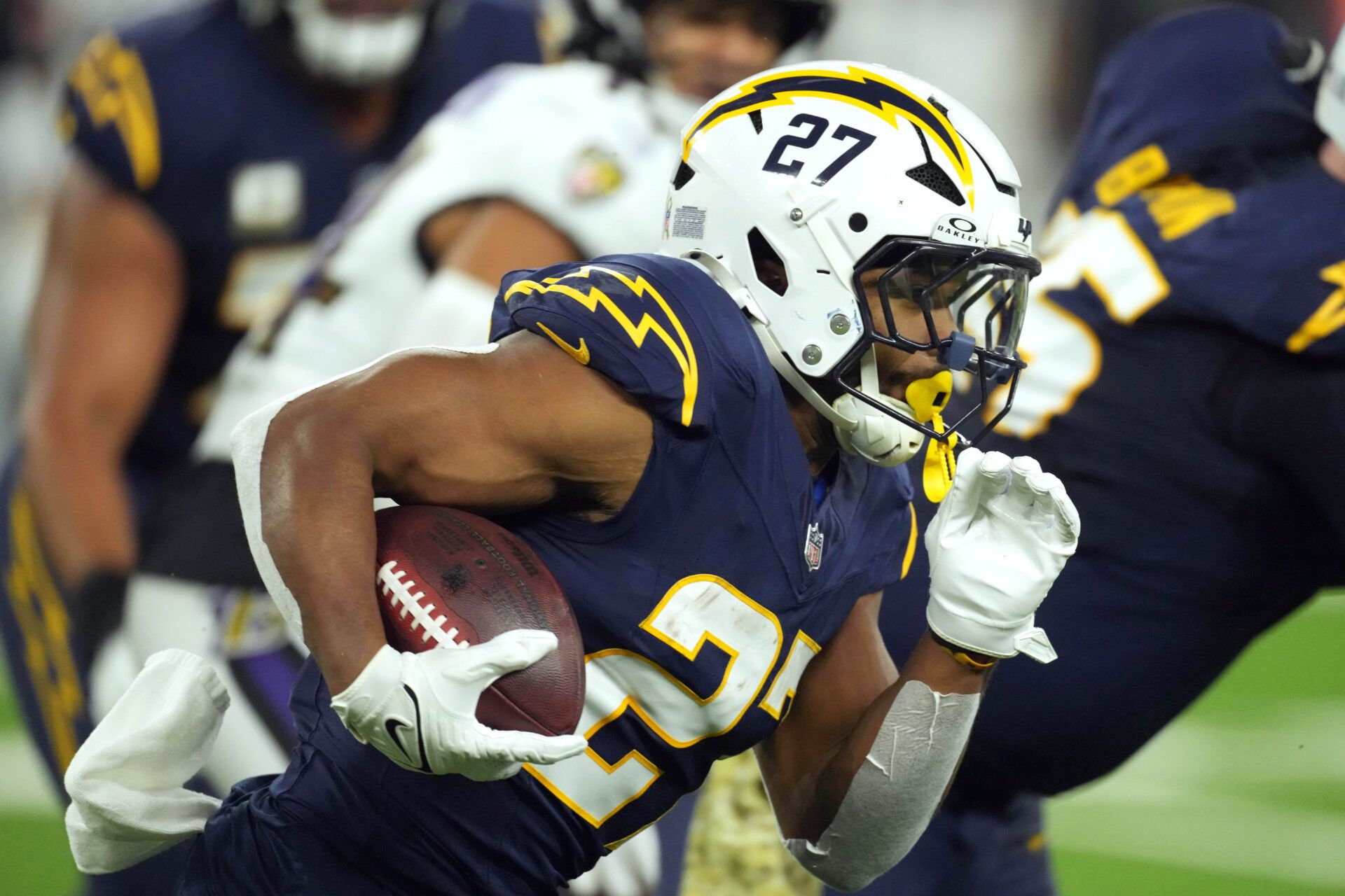 Nov 25, 2024; Inglewood, California, USA; Los Angeles Chargers running back J.K. Dobbins (27) carries the ball against the Baltimore Ravens in the first half at SoFi Stadium. Mandatory Credit: Kirby Lee-Imagn Images