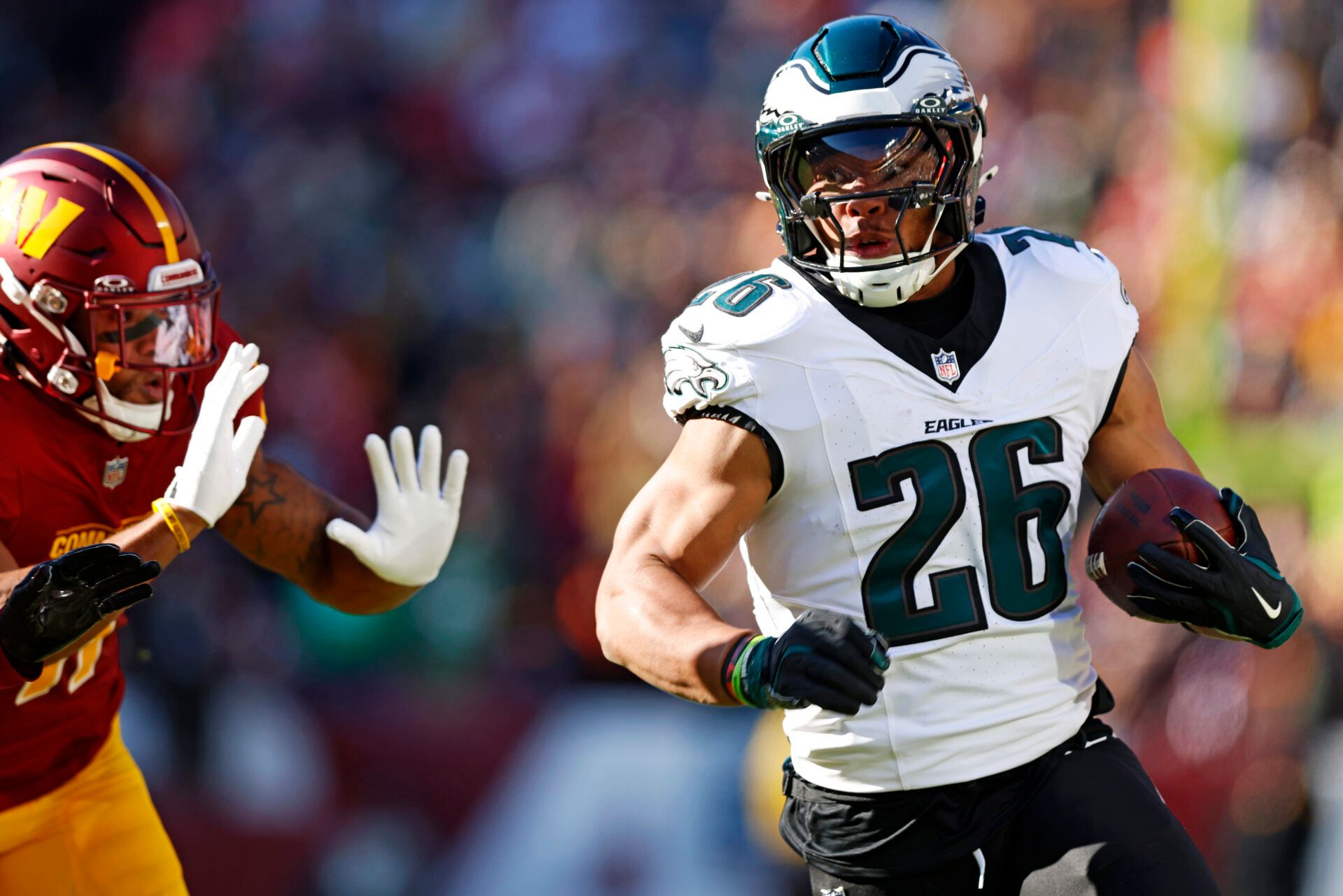 Dec 22, 2024; Landover, Maryland, USA; Philadelphia Eagles running back Saquon Barkley (26) runs the ball during the first quarter against the Washington Commanders at Northwest Stadium. Mandatory Credit: Peter Casey-Imagn Images