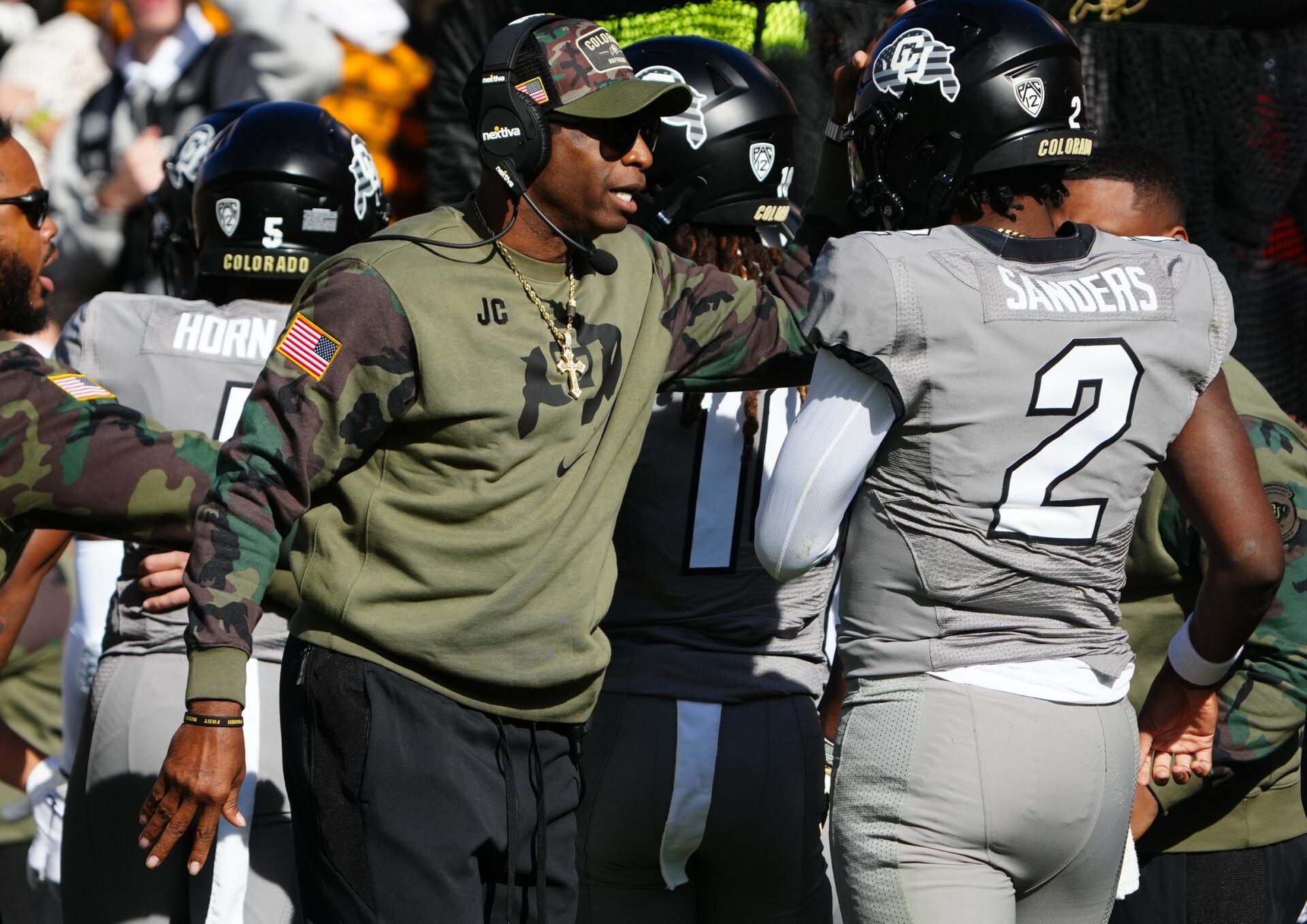 Colorado Buffaloes quarterback Shedeur Sanders (2) celebrates his touchdown with head coach Deion Sanders in the first half against the Arizona Wildcats at Folsom Field.