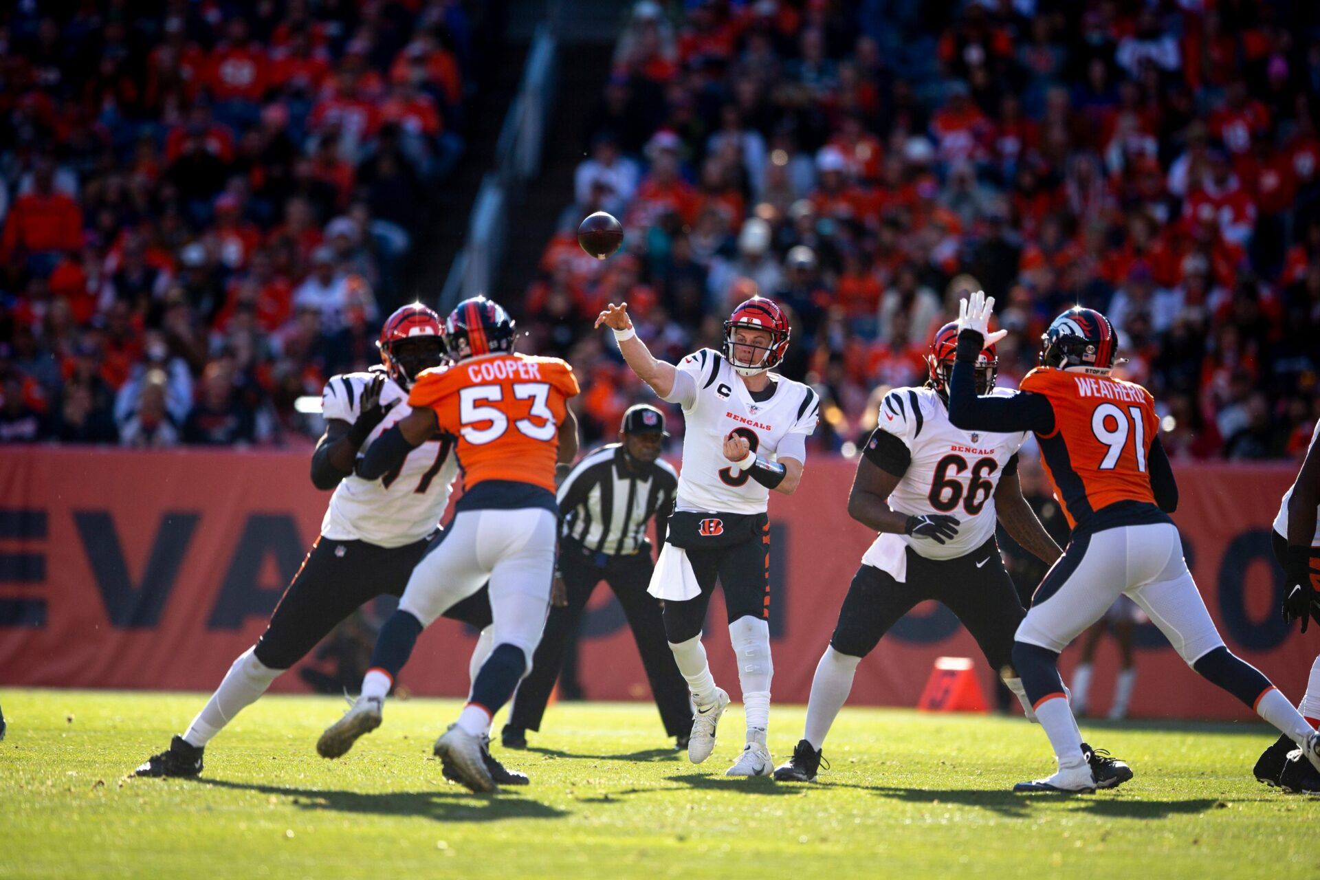 Cincinnati Bengals quarterback Joe Burrow (9) throws a pass in the first half of the NFL football game between the Bengals and the Denver Broncos on Sunday, Dec. 19, 2021, at Empower Field in Denver.