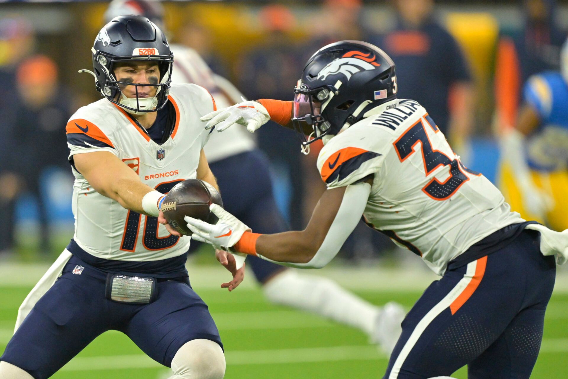 Dec 19, 2024; Inglewood, California, USA; Denver Broncos quarterback Bo Nix (10) hands off to running back Javonte Williams (33) in the first half against the Los Angeles Chargers at SoFi Stadium. Mandatory Credit: Jayne Kamin-Oncea-Imagn Images