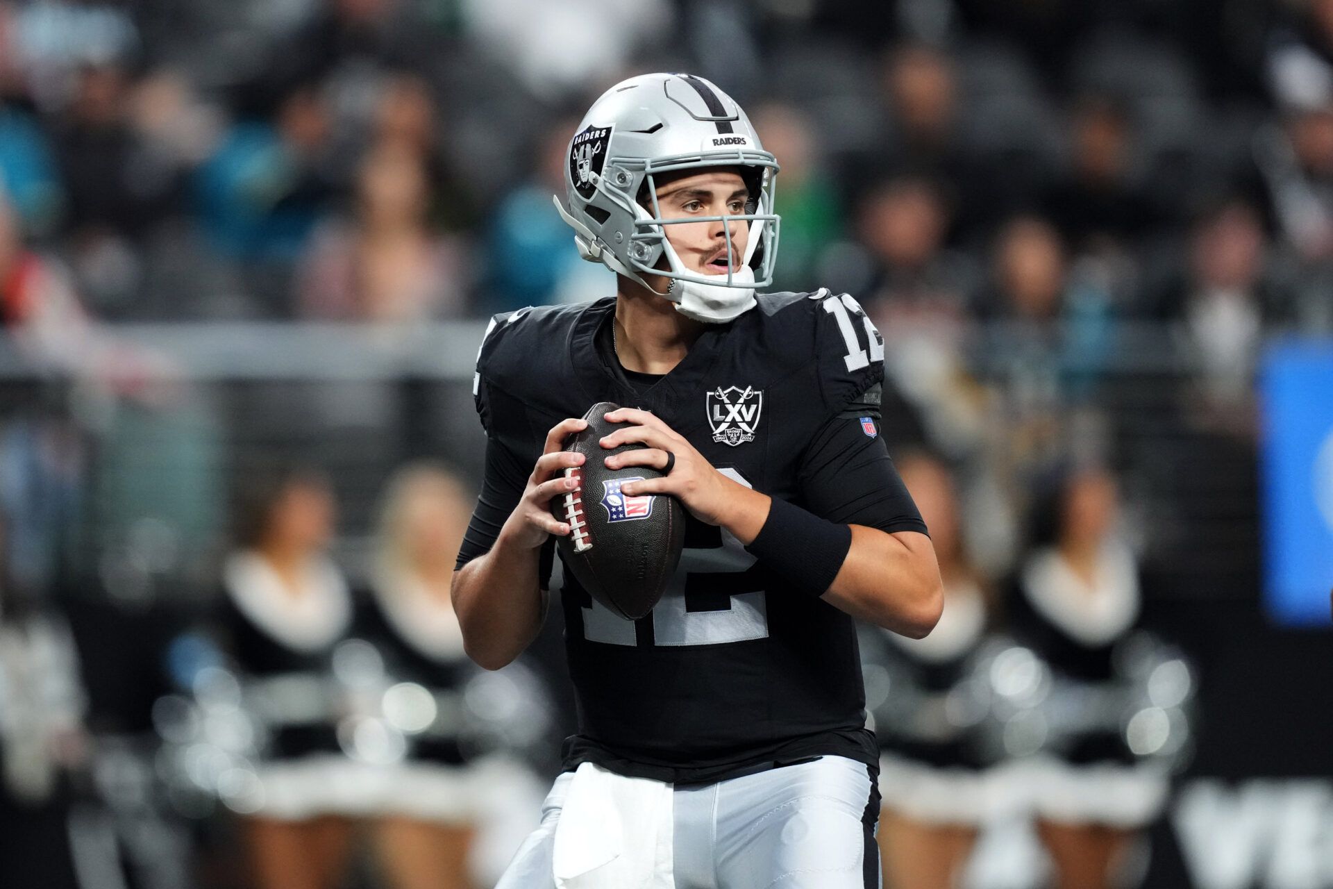 Dec 22, 2024; Paradise, Nevada, USA; Las Vegas Raiders quarterback Aidan O'Connell (12) throws against the Jacksonville Jaguars in the first half at Allegiant Stadium. Mandatory Credit: Kirby Lee-Imagn Images