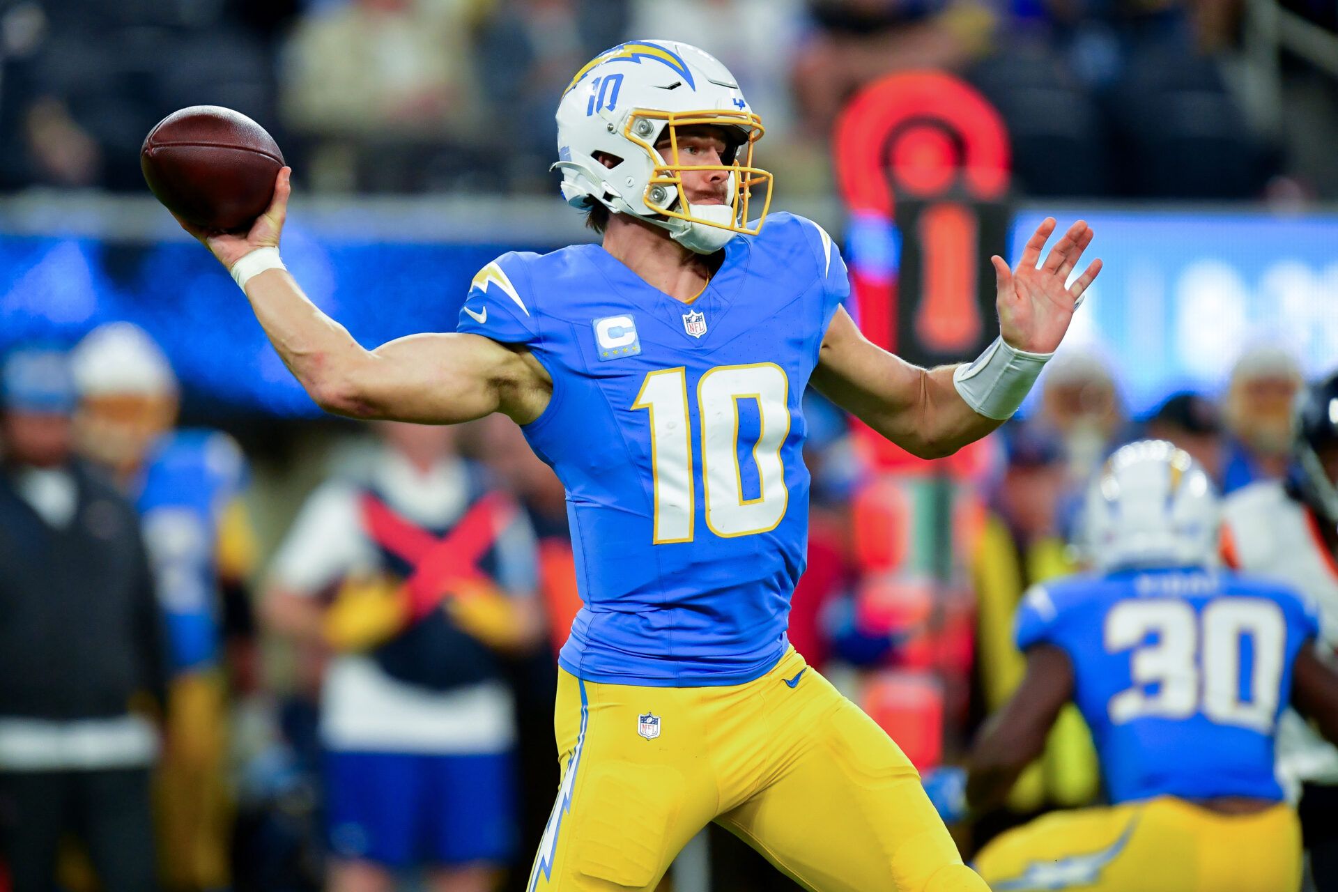 Dec 19, 2024; Inglewood, California, USA; Los Angeles Chargers quarterback Justin Herbert (10) throws against the Denver Broncos during the second half at SoFi Stadium. Mandatory Credit: Gary A. Vasquez-Imagn Images