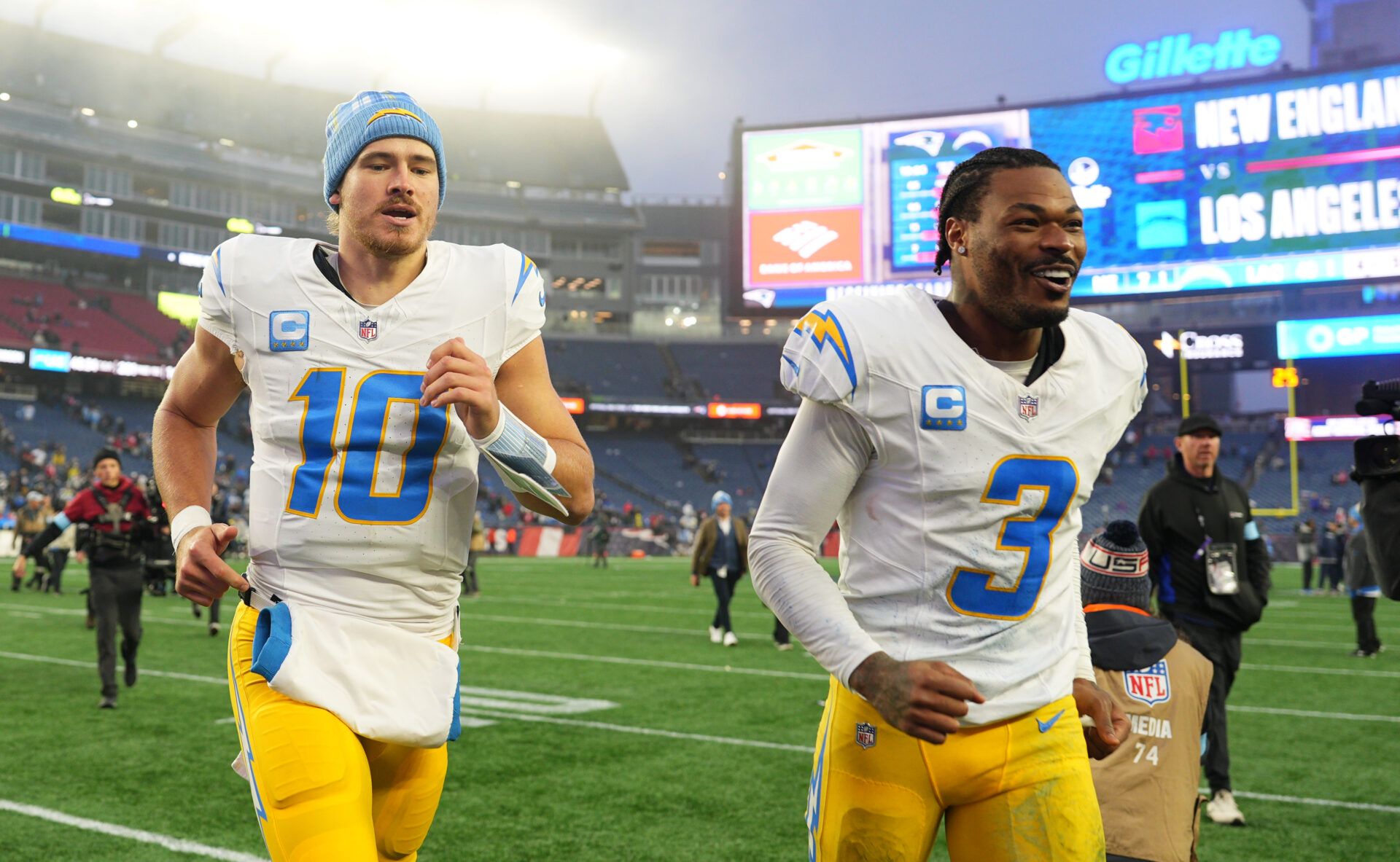 Dec 28, 2024; Foxborough, Massachusetts, USA; Los Angeles Chargers quarterback Justin Herbert (10) and safety Derwin James Jr. (3) run off the field after defeating the New England Patriots in the second half at Gillette Stadium. Mandatory Credit: David Butler II-Imagn Images