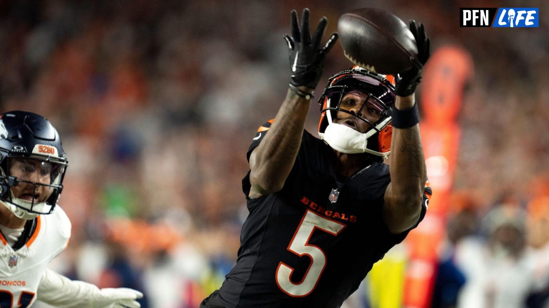 Cincinnati Bengals wide receiver Tee Higgins (5) catches a pass inside the 5-yard line as Denver Broncos cornerback Riley Moss (21) defends in overtime of the NFL game at Paycor Stadium in Cincinnati on Saturday, Dec. 28, 2024.